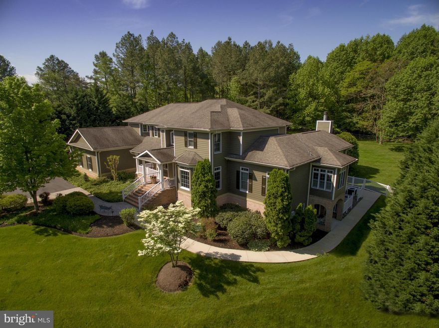 Inviting home in picturesque setting. Custom built 5 BR, 5BA, with clean lines, open floor plan, unique design for entertaining indoor and out. In-ground pool and gazebo on 1.31 beautifully manicured acres. Elevator services all three levels. Two-level in-law, au pair/guest suite with separate entrance. 4-car garage. Deeded 40' boat slip w/lift, 5.5' MLW in community marina.