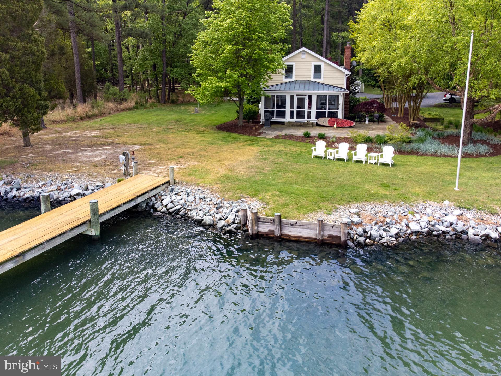 Picturesque Waterfront Cottage minutes from St. Michaels! This craftsman is the perfect “Get-Away” nestled on Grace Creek with plenty of privacy and surrounded by nature. Home has been beautifully maintained and updated featuring all of the amenties you would expect including knotty pine flooring throughout, kitchen with center island, granite tops, huge 6-burner Viking Stove and oven, Subzero Refrigerator, separate dining room, living/family room with stone-stacked wood burning fireplace, separate half bath and laundry/utility area. Upstairs includes 3 bedrooms and 1 full bath, which was recently renovated. You will spend most of your time on the large screened porch overlooking the water and admiring the workboats that slowly go by with their daily catch. The exterior includes a fenced-in gunite pool with Sunshelf/tanning ledge, stone decking, lush landscaping, standing seam roof over the porch, large hardscaped patio for entertaining and grilling. There is a solid pier electric and water, 10K lb boat life, bench, dock box and a filet station. 4’+/-MLW. Home complies with STR (short term rental) licensing guideines and can be purchased as a turn-key property, ready for summer!