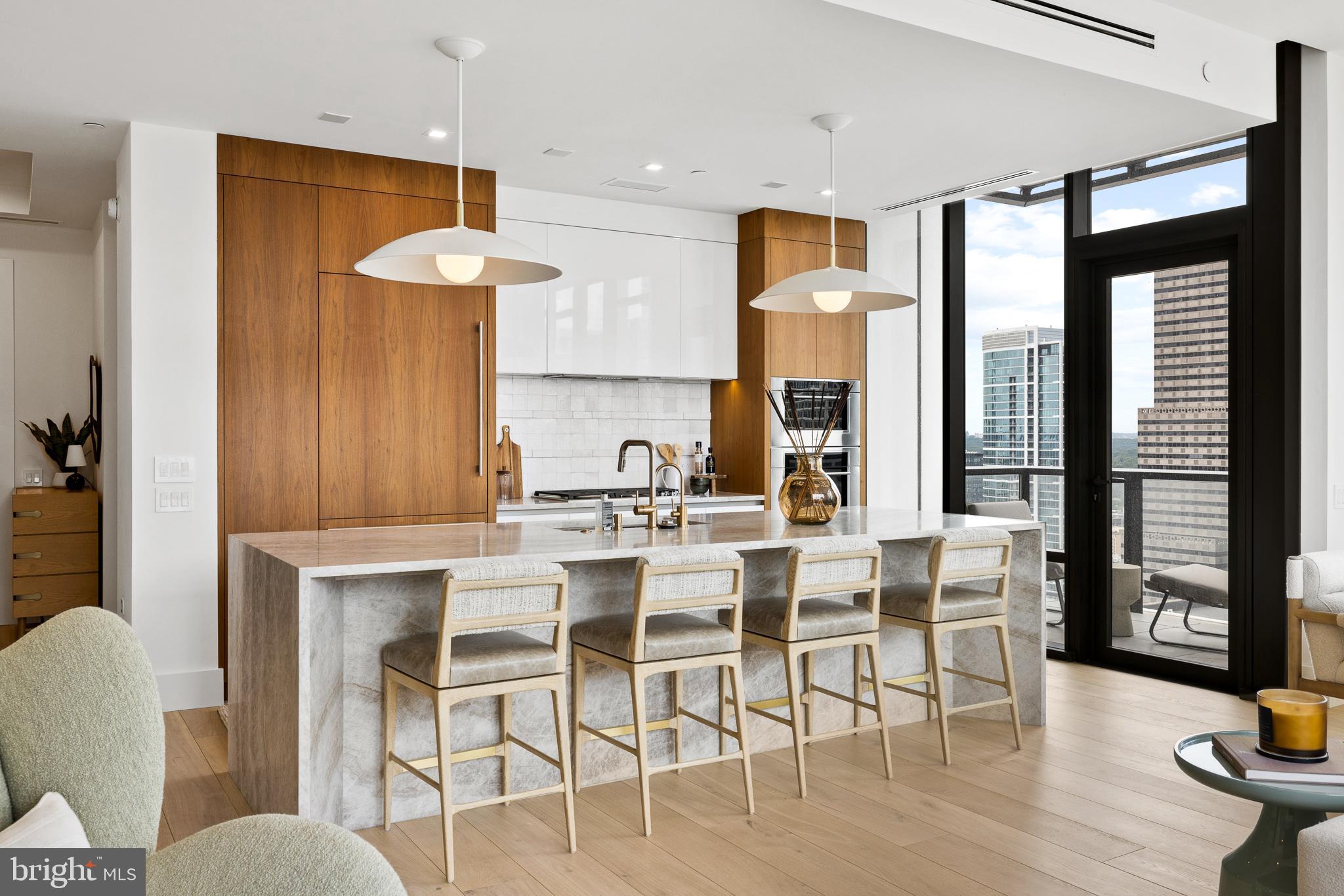 Welcome to Unit 2804 at The Laurel, an exquisitely upgraded 2-bedroom, 2.5-bathroom residence offering elevated living in one of Philadelphia’s most prestigious addresses overlooking Rittenhouse Square. This modern city home is a masterclass in sophisticated design, featuring high-end custom finishes, intelligent storage solutions, and refined architectural touches throughout. Upon entering, you are welcomed by wide, newly installed 11-foot Warren Christopher plank wood flooring that spans the living areas, creating a warm yet contemporary atmosphere. Anchoring the main living space is a custom-designed limestone fireplace, encased in white oak-stained wood with integrated LED-lit shelving and discreet hidden storage—perfectly blending function and style.
The gourmet kitchen is tailored for the modern chef, boasting a stunning quartzite slab with 22 thoughtfully positioned outlets, under-cabinet LED lighting, and a sleek Italian tile backsplash. The bar area and bathrooms have all been fitted with upgraded designer faucets, while the kitchen sink includes a premium Julian basin, upgraded garbage disposal, and a hot/cold filtered water system for added convenience. Adjacent to the kitchen, the laundry room has been thoughtfully transformed into a multifunctional space with built-in step stools, drying racks, upgraded washer and dryer, and dedicated electric access for charging your Dyson vacuum—an uncommon yet thoughtful feature in city living.
Both bedrooms offer generous proportions, enhanced by custom closet systems, recessed cam lighting, and electronic window shades for ultimate privacy and light control. The primary suite serves as a serene retreat, while the second bedroom is equally well-appointed. The half-bathroom stands out with an integrated sink, upgraded Morro fixtures, and custom lighting. Every detail throughout the home has been meticulously upgraded—from all new door hardware and custom light fixtures to repainted walls, added wallpaper accents, and upgraded baseboards for a cohesive and polished finish.
For peace of mind, the home is equipped with a built-in security camera, while smart lighting and shade systems contribute to the residence's modern appeal. This turnkey home is a rare blend of beauty and function, combining premium materials with bespoke design touches.
As a resident of The Laurel, you will enjoy access to an unparalleled suite of luxury amenities and full-service conveniences. Building amenities include an indoor and outdoor pool & hot tub, a stylish bar and lounge, 24-hour concierge, elevators, state-of-the-art fitness center, sauna, guest suites, golf simulator, meeting and party rooms, round-the-clock security, and even transportation services for added ease.