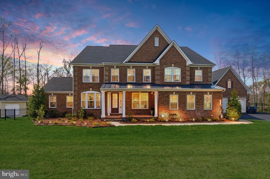 Exceptional 6,700+ sq ft luxury estate home situated on 5 private acres in Centreville, backing to serene trees and open fields, offering the perfect blend of privacy, space, and modern elegance. This stunning residence features a three-level open floor plan with high-end designer finishes and thoughtful custom details throughout, ideal for both everyday living and upscale entertaining. The main level welcomes you with a dramatic two-story great room highlighted by a coffered ceiling and a floor-to-ceiling stone fireplace, seamlessly flowing into the chef’s gourmet kitchen designed to impress with quartz countertops, an oversized island, stainless steel appliances, custom cabinetry, and a spacious breakfast area. The main level also includes a multi-generational in-law suite with a full bath, a private office or den, a large secondary laundry room with cabinetry and utility sink, a walk-in pantry, and an expansive screened-in porch perfect for outdoor living. Hardwood flooring extends throughout the main level, primary suite, and upper hallways. Upstairs, the luxurious primary suite offers a true retreat with a spa-inspired bathroom featuring a soaking tub, dual vanities, a separate shower, and an oversized walk-in closet, while all secondary bedrooms are generously sized and include en-suite bathrooms, providing comfort and privacy for all. The fully finished walk-out lower level is designed for entertaining and flexible living, featuring a media area, wet bar, guest suite with a full bath, ample storage, and direct access to the fully fenced backyard with wooded views. Exterior highlights include a 5-acre private lot, screened-in porch, metal fencing, storage shed, lawn sprinkler system, and a 4-car garage. Enjoy the tranquility of a private estate while remaining conveniently located with easy access to I-66, Route 28, and Route 29, just 10 minutes to Dulles International Airport, and close to Manassas National Battlefield Park. This is a rare opportunity to own a luxury estate home in Centreville offering unmatched space, privacy, and modern comfort.
