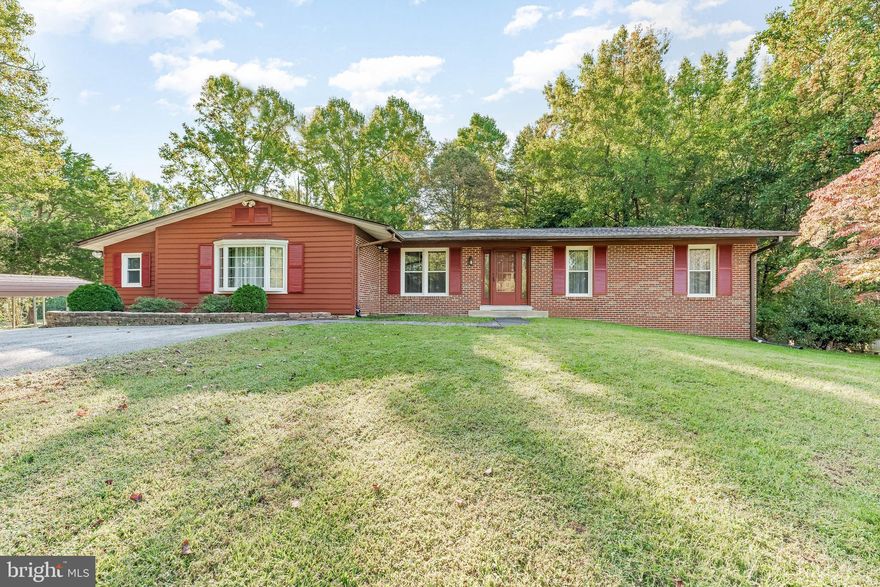 This stunning property offers the perfect blend of comfort and nature. Situated on a large wooded lot with a spacious flat yard, it's an entertainer's dream. With a total of 4 bedrooms and 4 baths, this home boasts 2 Primary Suites, Family Room, Living Room, Rec Room, Office and much more! The top level of the home spans 2,579 square feet and features 4 bedrooms, including 2 Primary Suites, each with its own bathroom. In addition to the 4 full bathrooms, you'll find a large living room with hardwood floors, a dining room, a galley-style kitchen with a pantry, a family room with a cozy fireplace, and a sunroom with cathedral ceilings and doors that open to a generous deck. The finished basement, offering 1,512 square feet of living space, is a walkout basement that includes a spacious rec room, a full bathroom, a wet bar in a versatile multi-purpose room, office/spare bedroom, a laundry/utility room, and a sizable storage closet. Outside, you'll enjoy a deck off the sunroom, a convenient carport, and a substantial shed/workshop on a concrete pad with electricity. Recent upgrades and maintenance include a new roof with a transferrable warranty in 2022, a furnace replacement in 2020, new appliances (washer, dryer, refrigerator) in 2020, and bathroom remodels between 2018 and 2022. The home is certified as lead-free by the MD Dept of the Environment, and it features energy-efficient windows installed in 2011. MAKE AN APPOINTMENT TODAY; DON'T MISS OUT ON THIS FANTASTIC OPPORTUNITY!