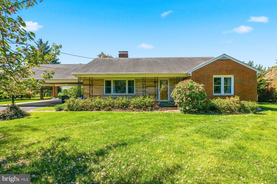 Adorable, classic 3BR/2BA Rancher with an attached two-car carport on a lush green lot in a quiet neighborhood.  Park in the double-wide driveway and proceed to the covered front entry of your new home.  This home offers tons of original character including original hardwood floors and  arched entryways. Step inside the living room, which has tons of natural light, a wood burning fireplace and an open view of the dining room and kitchen.  The kitchen features ample cabinets and countertops, a double stainless sink under a window, and very unique appliances.  Down the hall are two sizable secondary bedrooms, a larger primary bedroom with a walk-in closet and a second closet, and a full bath.  The lower level is semi-finished offering additional living space with a dry bar area in the recreation room which features knotty pine paneling, a full bath with a stand alone shower, laundry, storage, cabinets with a sink, and a walk-out to the yard through Bilco doors.  From the kitchen step outside to the covered carport—ideal when hosting family and friends—which leads to the lush green lawn with so many possibilities.  This home is ideal for the DIY homeowner who wants to make it their own.  Imagine all this in close proximity to shopping, restaurants, and commuter routes.