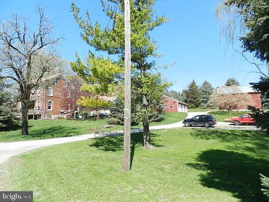 One of a kind brick 2 story farmhouse situated on over one acre of land with a large 3 car detached garage w/ 2nd floor, summer house and barn.  Home features 4 bdrms, a first floor bathroom, eat-in kitchen, a partially finished basement with walk out, covered front and rear enclosed porch, replacement windows, updated elect. Summer house is perfect for a home office, craft studio, etc. Plenty of storage space in the barn. Many possibilities!