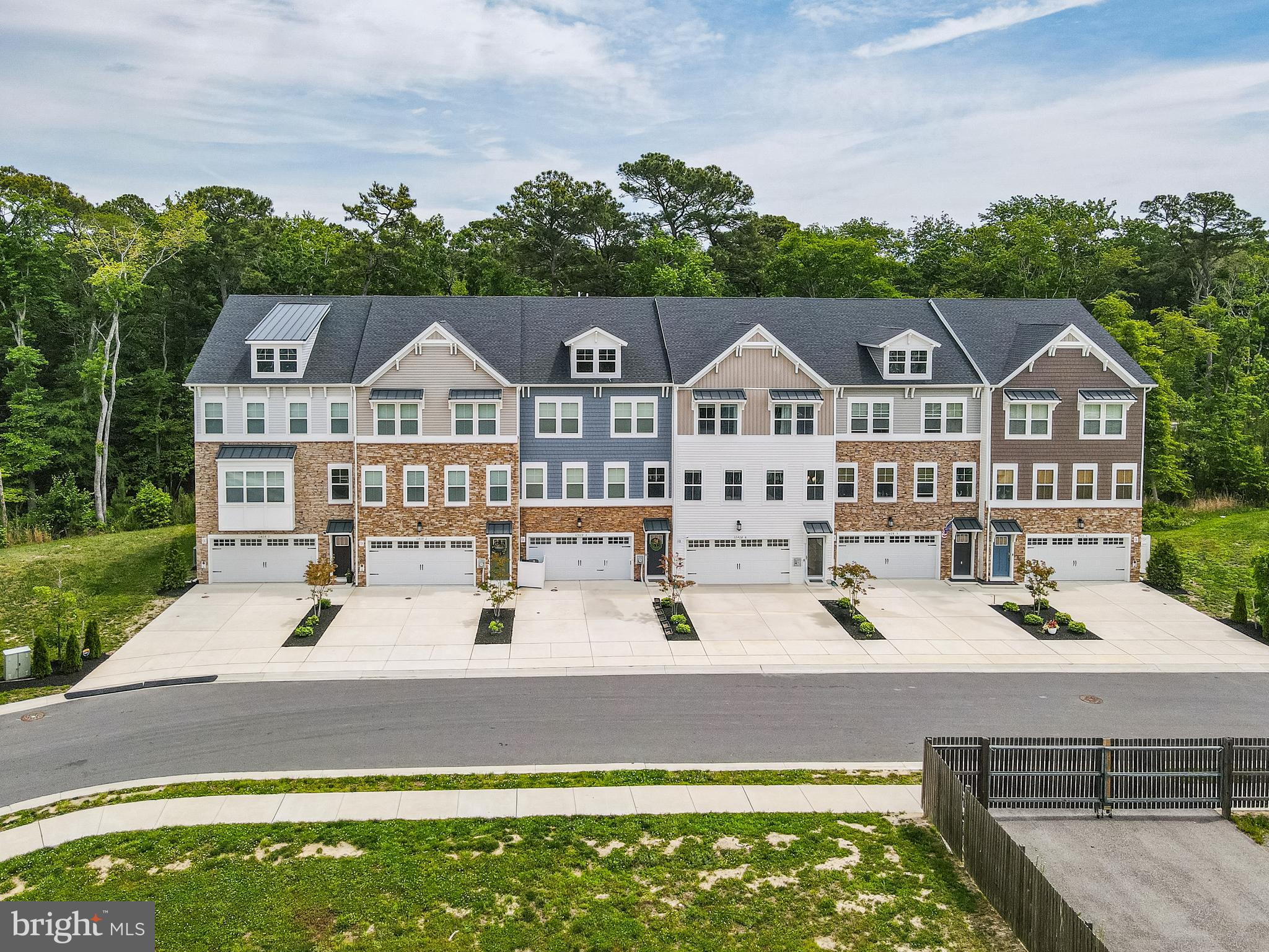 Welcome to coastal living at its finest in Sea Oaks Village! This beautifully appointed 5-bedroom, 4.5-bath townhome offers four levels of thoughtfully designed space, perfect for year-round living or a beach getaway. The first floor features a 2-car garage with a workshop area and utility sink, a spacious hallway with built-in coat rack, and a private bedroom with en-suite bath—ideal for guests or multigenerational living.
The second floor boasts an open-concept layout with a seamless flow between the living room, dining area, and kitchen, all leading to a generous balcony perfect for outdoor entertaining. The chef’s kitchen shines with granite countertops, a large center island, stainless steel appliances, and designer-selected cabinetry.
Retreat to the owner’s suite on the third floor, complete with a large walk-in closet, dual sink vanity, and a walk-in shower featuring a glass enclosure and ceramic tile surround. Two additional bedrooms and a full hall bath provide ample space for family and guests.
Enjoy all that Sea Oaks Village has to offer, including a community pool, playground, tennis and pickleball courts, and a basketball court. Located just minutes from Assateague Island and Ocean City beaches, this home truly has it all—comfort, style, and convenience.
Don’t miss this opportunity to own in one of the area’s most sought-after communities!