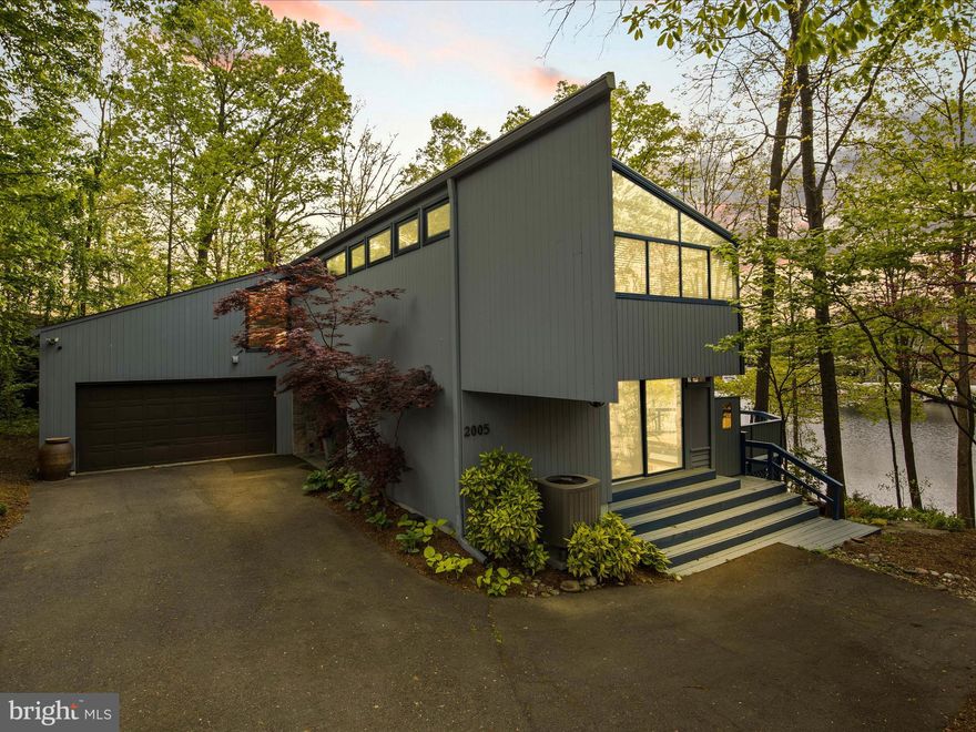 Welcome to Luxury Lake Living in Reston!  This beautiful contemporary house is one of a kind.  With nearly 5000 SF on 1/3 of an acre,  you will be amazed by it inside and out.  With 180 degrees of water views and water frontage, this home offers a lifestyle that is rare to find in the DC Metro area.  This home once featured on Reston's Home tour features 4 bedrooms and 3 full bathrooms including main level living.  The customizations to this home are unparalleled.   The house features hardwood floor, gourmet kitchen, viking appliances, a plethora amount of windows, a wine cellar, custom walk in closets, a home theatre like layout in the basement,  spa like bathrooms with large soaking tub in the primary suite, extensive outdoor space, a private dock and a floating dock that can be motorized to cruise around the lake.  Don't miss the opportunity to own your own slice of heaven in Reston.  The Metro is roughly 1 mile away too.  Location location location!