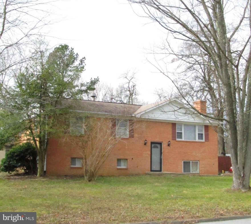 4 Bedroom 2.5 Bath home with renovated kitchen, updated bathrooms and beautiful hardwoods throughout the main level.  Basement is fully finished with fireplace and bar in Rec Room. Large utility space and large additional bedrooms in the basement help to give you a home that is larger than it looks from the outside! Great commuter location!