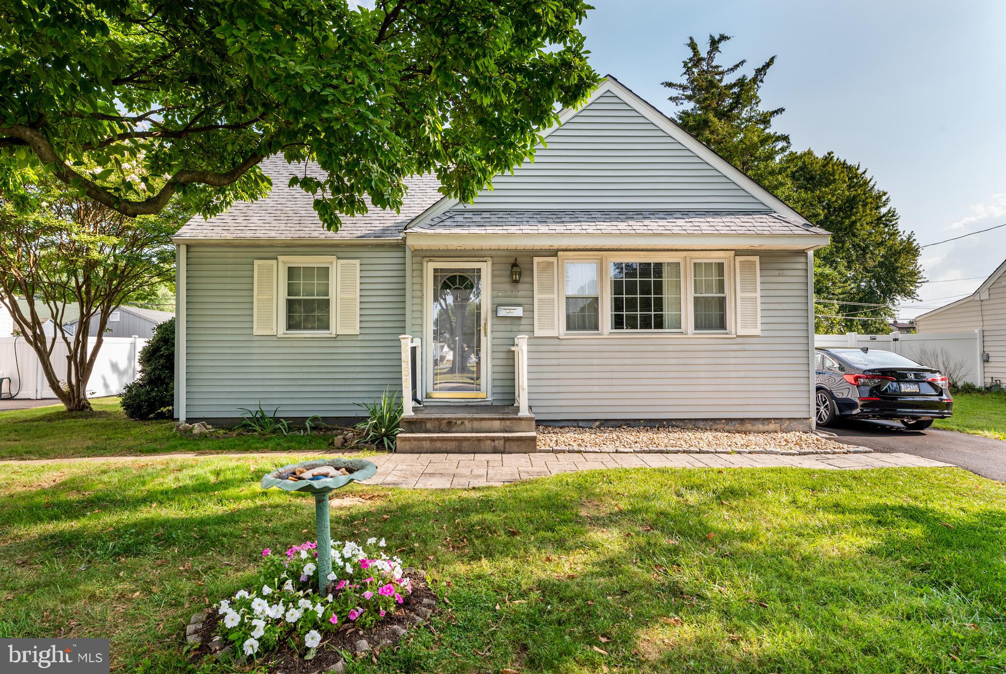 Delightful 3+ Bedroom Cape on quiet street with very spacious yard. This house has been lovingly and meticulously maintained by the same family for over 50 years. Hardwood floors throughout the first floor. A handsome paver path leads to the front door. Inside you'll find a sunny Living Room (with a NEW window on the driveway side), eat-in Kitchen, and two Bedrooms on the first floor. There is also a RENOVATED full bath with a stall shower with frameless glass doors and a pretty pedestal sink on this floor.  Laundry is neatly tucked away in a closet off the Kitchen. Upstairs you'll find a very spacious Bedroom which is connected to a bonus room (and could be easily converted into two separate bedrooms). There is also plenty of eaves storage on second floor including some concealed behind a moveable bookcase! There is a small deck off the back of the house that leads to a gorgeous, large, fenced in yard with plenty of space for gardening or a play set to (or both!). The driveway is long, offering plenty of off street parking, and was recently repaved and resurfaced. Very well maintained and well loved home! NEW electric box (2024), NEW PECO service line (2024), newer heater (2018), newer sidewalks, newer curb, newer sewer line, newer water line and much more. Penn Delco Schools. Don't miss the opportunity to make this lovely home your own.