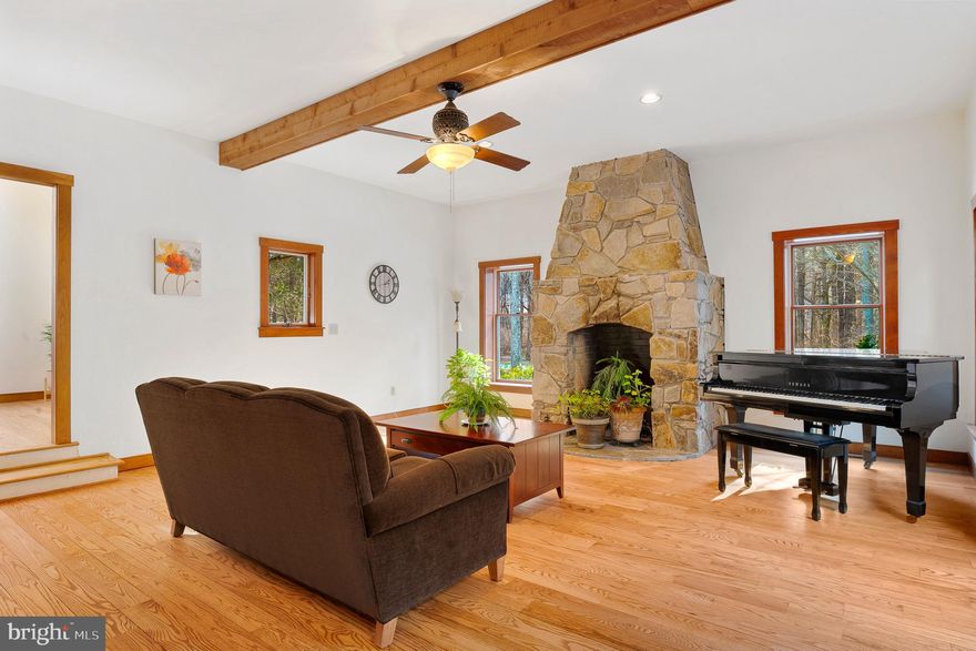 Privately set on 5.22 picturesque acres zoned Agricultural, this distinctive residence blends refined comfort with timeless lodge-inspired design and is now offered at $900,000. The home features four bedrooms, including two primary suites—one on the main level and one upstairs with an adjoining sunroom and bonus or hobby room—offering exceptional flexibility.

A dramatic lodge-style family room anchored by a floor-to-ceiling stone fireplace and enhanced by skylights fills the home with natural light. The custom kitchen offers quality cabinetry, a large pantry, and a generous eat-in granite island ideal for entertaining. The upper-level primary bath provides spa-like comfort with a claw-foot soaking tub, tiled shower, bidet, and skylights.

Outdoor living includes a wraparound deck overlooking the serene landscape and a walk-out unfinished basement prepped for future finishing. Additional highlights include first-floor laundry, Andersen windows throughout, a new roof (2025), 2x6 exterior wall construction, wired for a generator, and a whole-home insulation upgrade (2020). An outbuilding and fenced area for animals complete this rare agricultural offering.

A property of remarkable character, privacy, and flexibility—now positioned to meet today’s market.