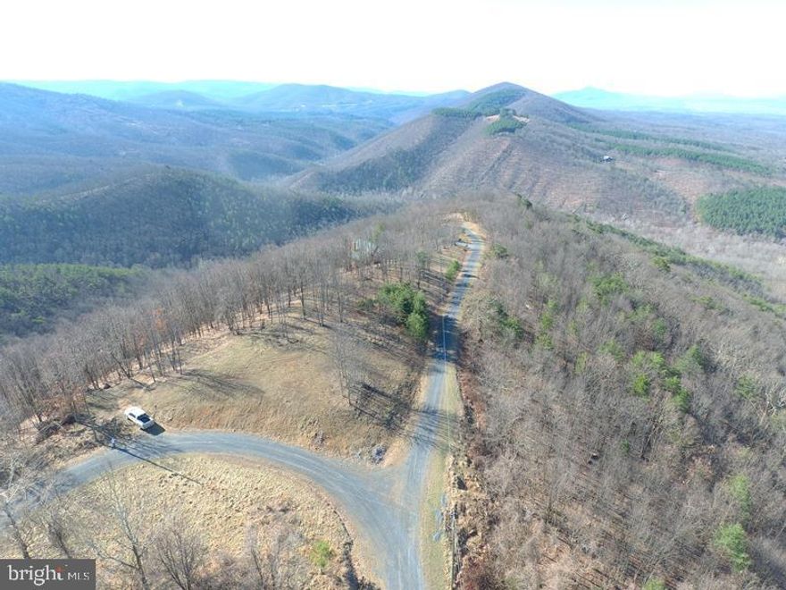 WHEN THE VIEW IS ALL THAT MATTERS.....25 ACRES WITH 280 DEGREE PANORAMIC VIEWS, CLEARED BUILDING SITE MAKES THIS ONE EASY TO FIGURE OUT, THE PICTURE HAS BEEN PAINTED! LOCATED IN THE PRESTIGIOUS 10,000 ACRE GATED COMMUNITY ASHTON WOODS, A ONE OF A KIND PLACE, WHERE YOU CAN ESCAPE THE WORK & WORRY OF THE BIG CITY AND TICKLE ALL YOUR OUTDOOR FANCIES....20 MINUTES FROM WAL MART, RESTAURANTS, 4 LANE SUPER HIGHWAY AND MULTIPLE PUBLIC ACCESS POINTS ON THE SOUTH BRANCH OF THE POTOMAC RIVER, 45 MINUTES FROM SKI RESORTS AND AN EASY 2 HOUR DRIVE FROM NORTHERN VIRGINIA. IF YOU LIKE THE OUTDOORS, YOU'LL NEVER GET BORED.