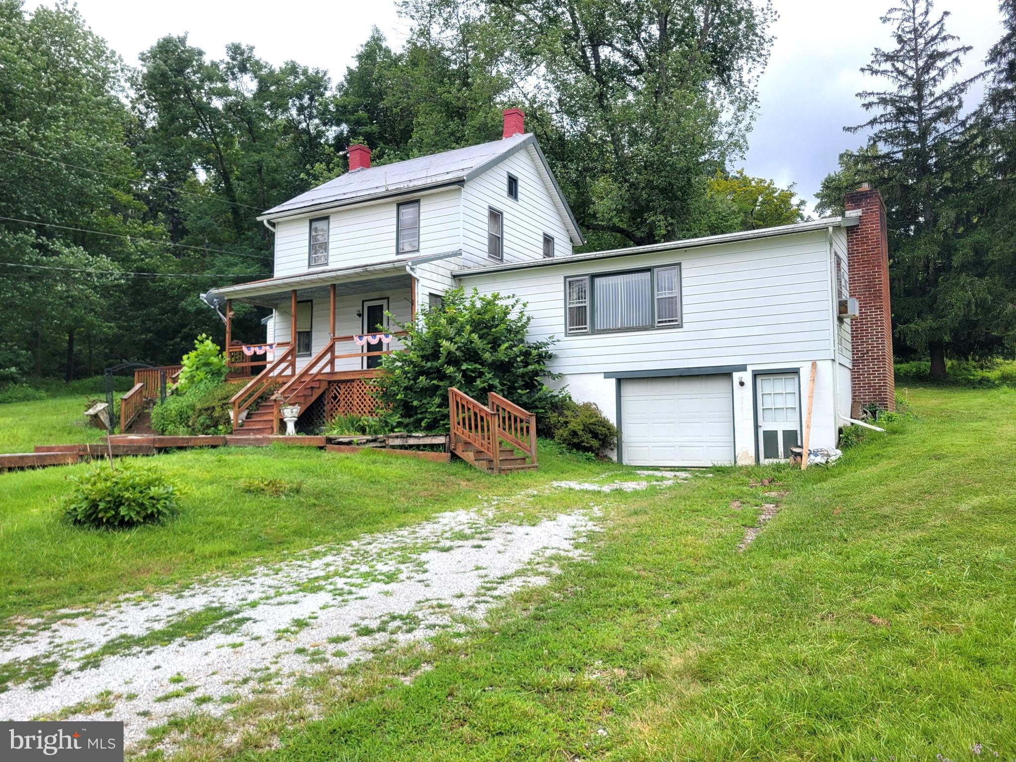 Picturesque setting on 12.60 acres in Liberty Twp. This farmette has roughly 10+ tillable acres with a 3 bedroom, 2.5 bath farmhouse, and a large pond. The house sits up on an elevated spot of the property giving amazing views from the front porch. House does need some TLC inside and out. On the main floor is a bright country kitchen, family room, dining area, 1.5 baths, and a large rec room with a bar and fireplace. Upstairs are 3 bedrooms and another full bath. There's also a walk up attic for storage. There's a basement under the main part of the house, and there's a 1 car garage and storage area in the lower level too. 20 minutes east of Waynesboro, and 20 minutes south of Gettysburg.