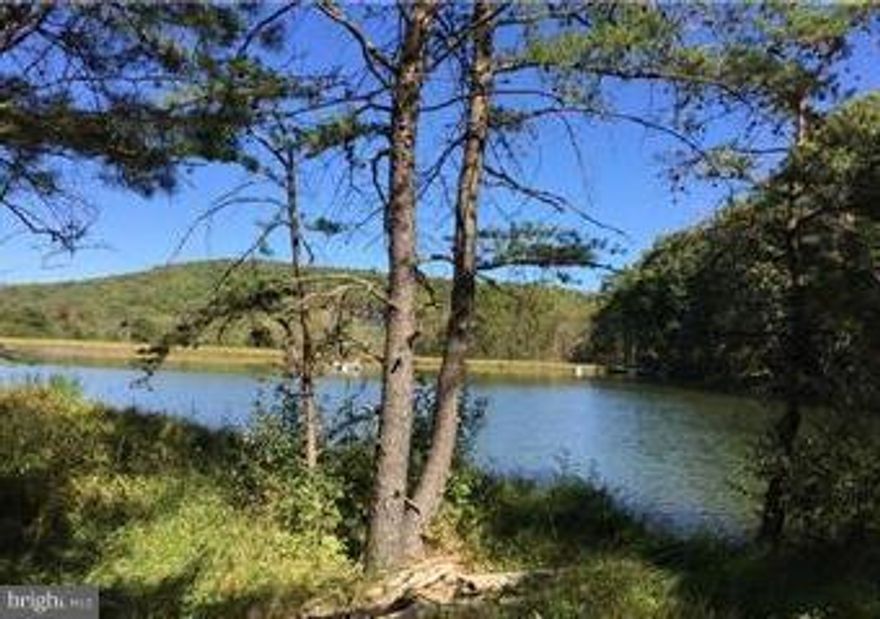 This nicely wooded 2.1 acres is located in quiet private sub-division with large lake with dock and beach area for boating and swimming. Located adjoining CaCapon State Park and only 7 miles from Historic Berkeley Springs. Land has current well and septic permits on file.This is a residential building lot  Very appealing sub-division and fantastic area come see today.