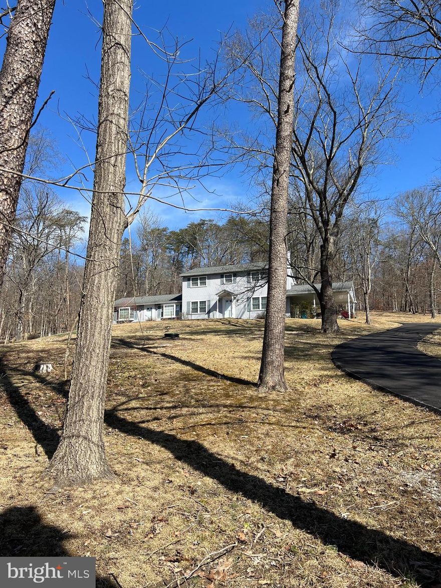 This charming two-story Colonial home,  situated  on 13+ serene wooded acres, offers the perfect balance of privacy and convenience.  The 13-acre lot provides endless outdoor opportunities for recreation, gardening, or simply enjoying the beauty of the surrounding woods. Whether you're relaxing on the patio, exploring the trails through the woods, or having a family barbecue in the backyard, this home offers something for everyone. Located in the highly sought-after Oakdale school district, this property is ideal for those looking for tranquility without sacrificing access to top-notch schools and nearby amenities.
Inside, the main level features a spacious traditional floor plan with abundant natural light streaming through large windows . A standout feature is the main-level bedroom, perfect for guests, multigenerational living, or anyone who prefers avoiding stairs. This bedroom is conveniently located near a full bath, making it both functional and private.  Also on main level is a private office/den , featuring it's own entrance, for those home-based businesses.  Quality construction includes hardwood flooring, cherry kitchen cabinetry, quartz counters and  numerous built ins.  Mud room off of carport provides plenty of storage.  Enjoy the wood burning fireplace in the living room with additional built in custom cabinetry.
With a fresh coat of paint, you will have a turnkey home ready for years of creating those special moments.