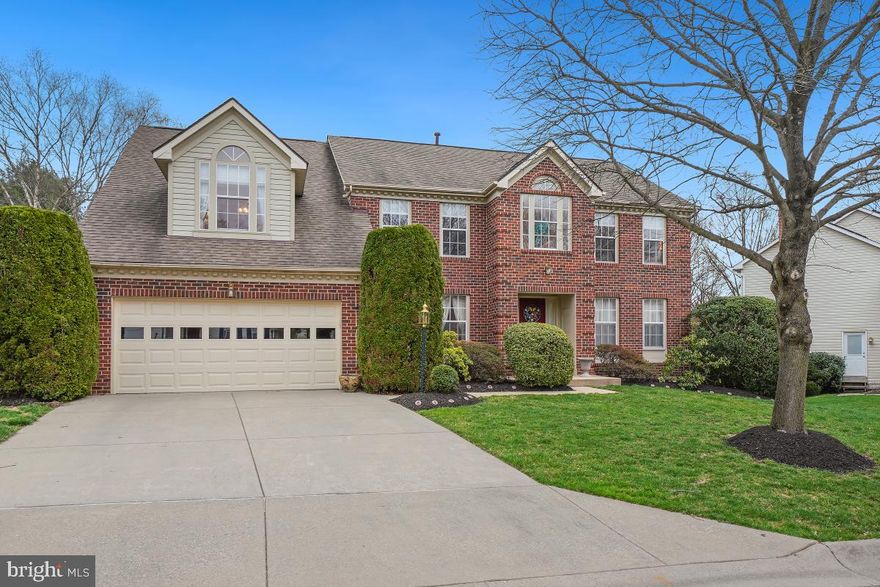 Lovingly cared for by its original owners, this center hall colonial radiates warmth, comfort, and an undeniable sense of home. The house has a stately front brick facade, elegant circle-top windows, a two-car garage, and is professionally landscaped. Entering the home, find yourself in the two-story foyer with hardwood flooring. A convenient coat closet is along the hall. Off to the right is the living room, which has four windows, and access to the office. The formal dining room has two front yard facing windows and connects to the kitchen and breakfast area.  Enjoy the deck and backyard views through the breakfast nook’s big bay window. A convenient desk is built into the kitchen.  Granite countertops stretch around the room, and the center island has a matching granite countertop and built-in gas stovetop. There is also a tile backsplash, double oven and pantry closet.  Just off the kitchen on this main level is garage access, and the mudroom/laundry room which has outside access. There is also a half bathroom on the main level. An expansive family room features a floor to ceiling gas fireplace with brick surround, a cathedral ceiling with two skylights, and a set of French doors that open to the exterior Trex deck with steps leading down the backyard. Upstairs, the spacious primary suite has high vaulted ceilings and a skylight, a sitting area, a vanity area, a sizeable walk-in closet, and a large bathroom. This bathroom features an inviting soaking tub, a walk-in shower, and a vanity area with a skylight.  The hall bath has a tub/shower and a linen closet. There are three additional bedrooms upstairs. This house has a walk-out basement. You’ll find it in the recreation room downstairs, with recessed lights and a sliding glass door to the backyard. A hallway leads down to the full bathroom on this level. There’s also a huge storage room with utilities, various workspaces, and built in shelving.  Newer carpet is throughout the house, and a new floor is in the kitchen area. Other recent improvements include a double oven and a new garage door. The attached two-car garage has built-in shelves and ensures everything has its place. Sited on a quiet cul-de-sac in the sought after neighborhood of Quince Haven, this property is just minutes to major highways, parks like Seneca Creek State Park, and shopping and restaurants in the Kentlands. Don’t miss this opportunity to make this home your very own!