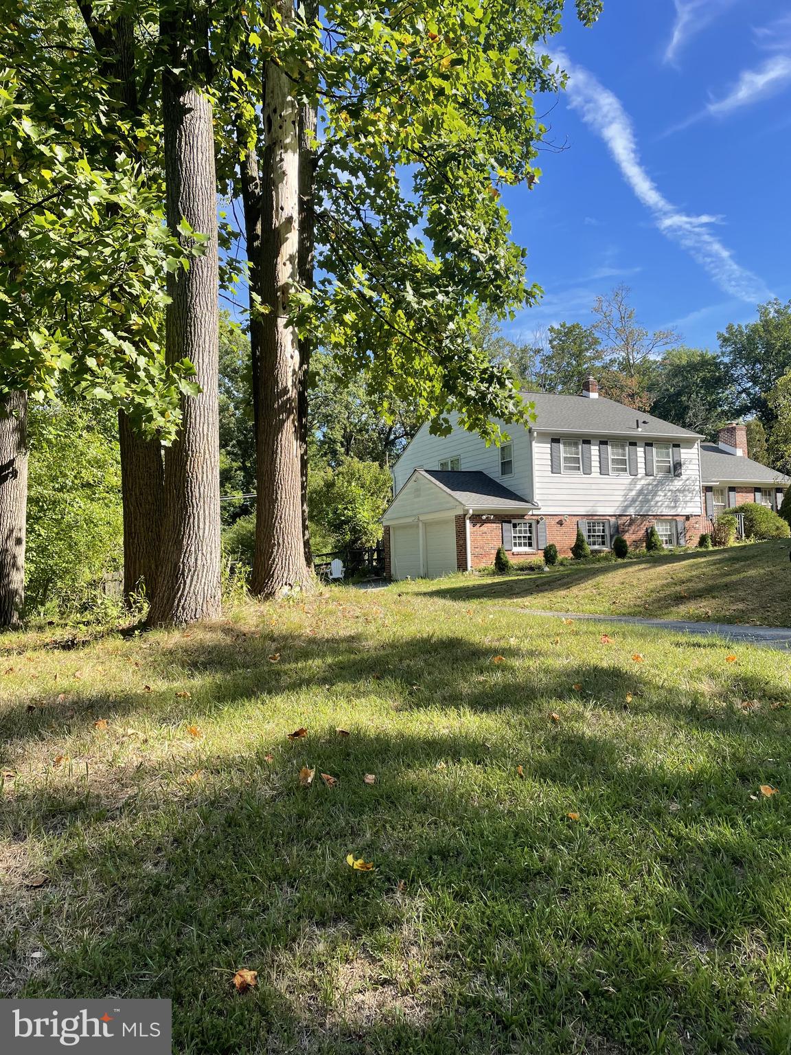 Buffered by preserved parkland and set at the corner of Contention Lane, this renovated Devon home enjoys rare quiet, treetop views, and a secluded backyard deck. Granite kitchen, updated HVAC, 2-car garage, and close proximity to T/E schools and Valley Forge. Inside, sunlight filters through generous windows into a spacious main living area with mid-century proportions and hardwood floors. The remodeled kitchen features granite countertops, center island, custom cabinetry, and modern appliances. Upstairs includes three well-sized bedrooms and two updated bathrooms, while downstairs includes a large den, powder room, laundry area, and direct access to a private lower patio. The oversized two-car garage connects to a wide driveway with ample parking. As the last home on the street before Valley Creek and the trail system, the property combines privacy, nature, and neighborhood living in one of the Main Line’s most cherished townships.