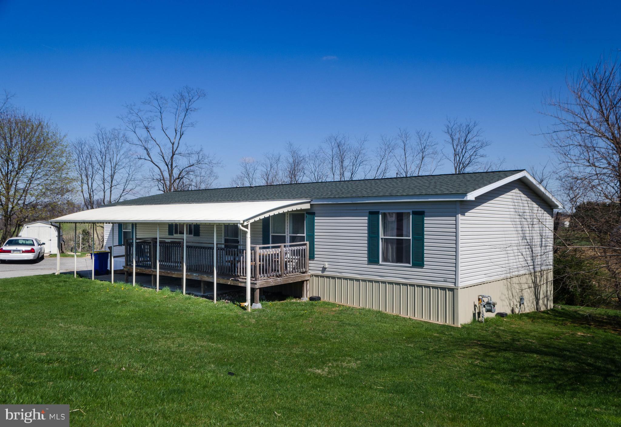 Extremely nice one owner Pine Grove double wide mobile home available in the pleasant and conveniently located Windy Brae Mobile Home Community. Mobile home located at the edge of the park and has a nice private rear yard that backs up to tree line and shrubbery. Three ample sized bedrooms, all with walk in closets. two full baths and a bonus half bath off the laundry/storage room. Wonderful oak kitchen with a center island. Newer Stainless Steel Appliances. Roof and Central Air Conditioning new approx. 5 years ago. New walk in shower in Master Bath with subway tile and glass sliding doors. New Hot Water Heater and newer carpet in Living room. Covered front deck with a handicap ramp. Vinyl Skirting replaced around the entire mobile home 3-4 years ago. A Generac Generator also installed a few years ago. Lot Rent is $440 a month