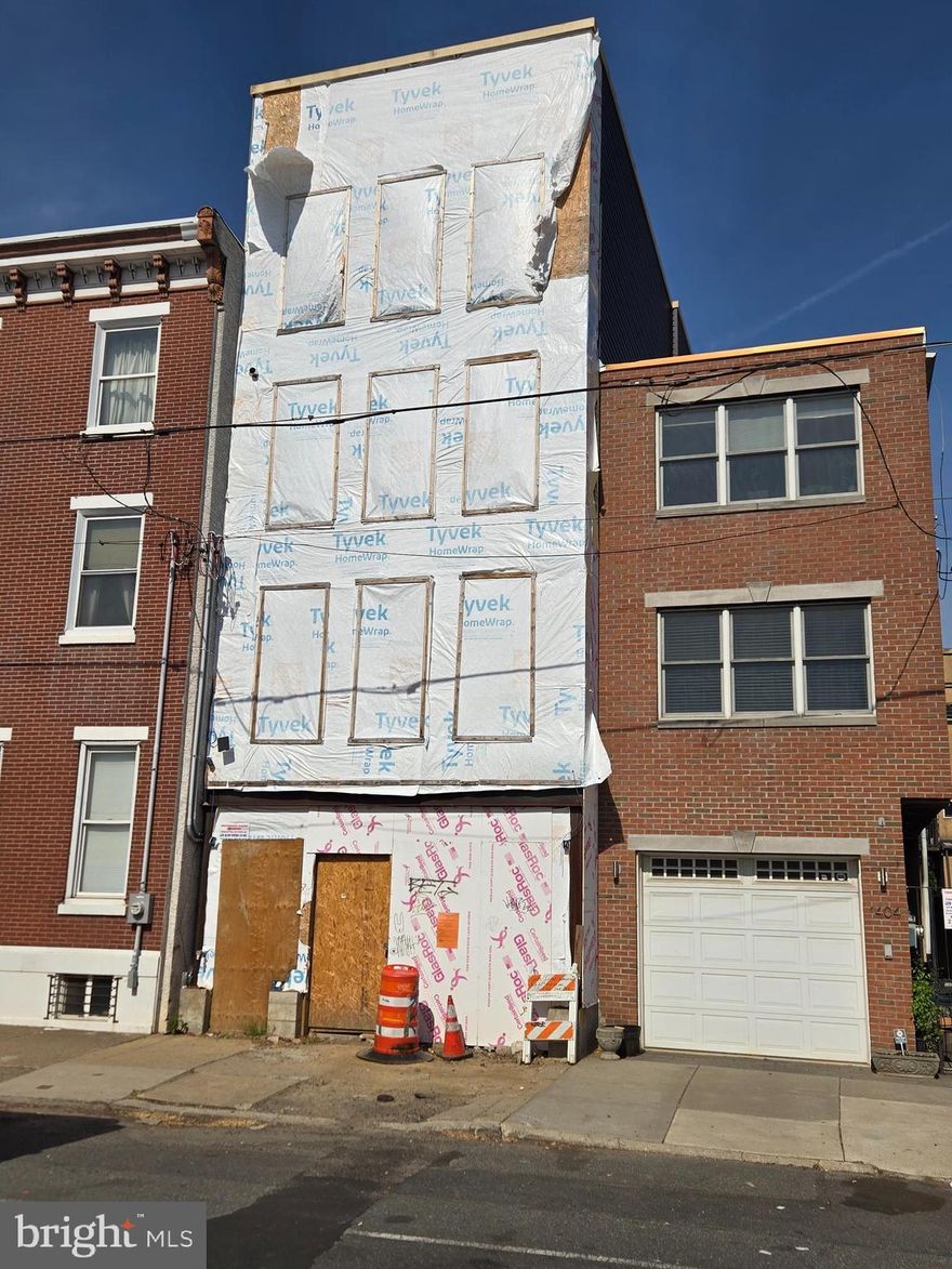 Here’s your chance to finish building your dream home in the heart of Pennsport, one of South Philadelphia’s most sought-after neighborhoods! Located at 1406 E Moyamensing Ave, this property is fully framed with electrical and plumbing rough-ins already completed and includes plans for a spacious layout featuring 2-car GARAGE PARKING, 3 bedrooms, 3 living rooms, and 4 bathrooms. This home offers incredible potential for customization in a vibrant and walkable community. Buy this property as is or ask the seller to complete the build for which they can provide a quote tailored to your specific finish selections and design preferences—don't miss this opportunity to create the home you’ve always envisioned! All square footage numbers are approximate and should be verified by the buyer. It is the responsibility of the buyer to verify real estate taxes.