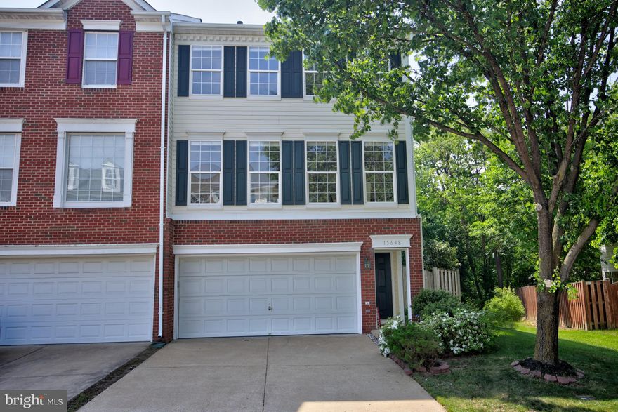 Beautiful, end unit townhouse with an open and incredibly spacious floor plan. The original owner has taken meticulous care and just installed brand new carpeting  and professionally painted the whole interior so it is ready for you to move right in to!!! The stunning kitchen with hardwood flooring, gas cooking, center island and upgraded, 42 inch cherry cabinets with a complementary granite, is open to a cozy family room with a gas fireplace.  The open, dual staircase lets you appreciate the size of this end unit! A front load, 2 car garage, walks in to a spacious recreation room complete with a full bath and walks out to a brand new deck in the fenced yard backing to trees. This home also comes with an in-groud sprinkler system! The maximum privacy and walk way from the front to the back gate is ideal for outdoor parties as the lower deck connects to the upper deck with a custom staircase. Four, oversized windows across the front on the main and upper levels lets the light pour in all day long. The primary suite with a garden bath and walk-in closet is located at the back of the house so it is quiet and private! WALK TO THE VRE COMMUTER TRAIN!!! All of this tucked away in sough-after Riverside Station is a commuter's dream!!! On  the weekends, take advatage of the abundant stores and restaurants and shopping at Potomac Mills or head south app. 60 minutes to King's Dominion or a little over an hour to Lake Anna!