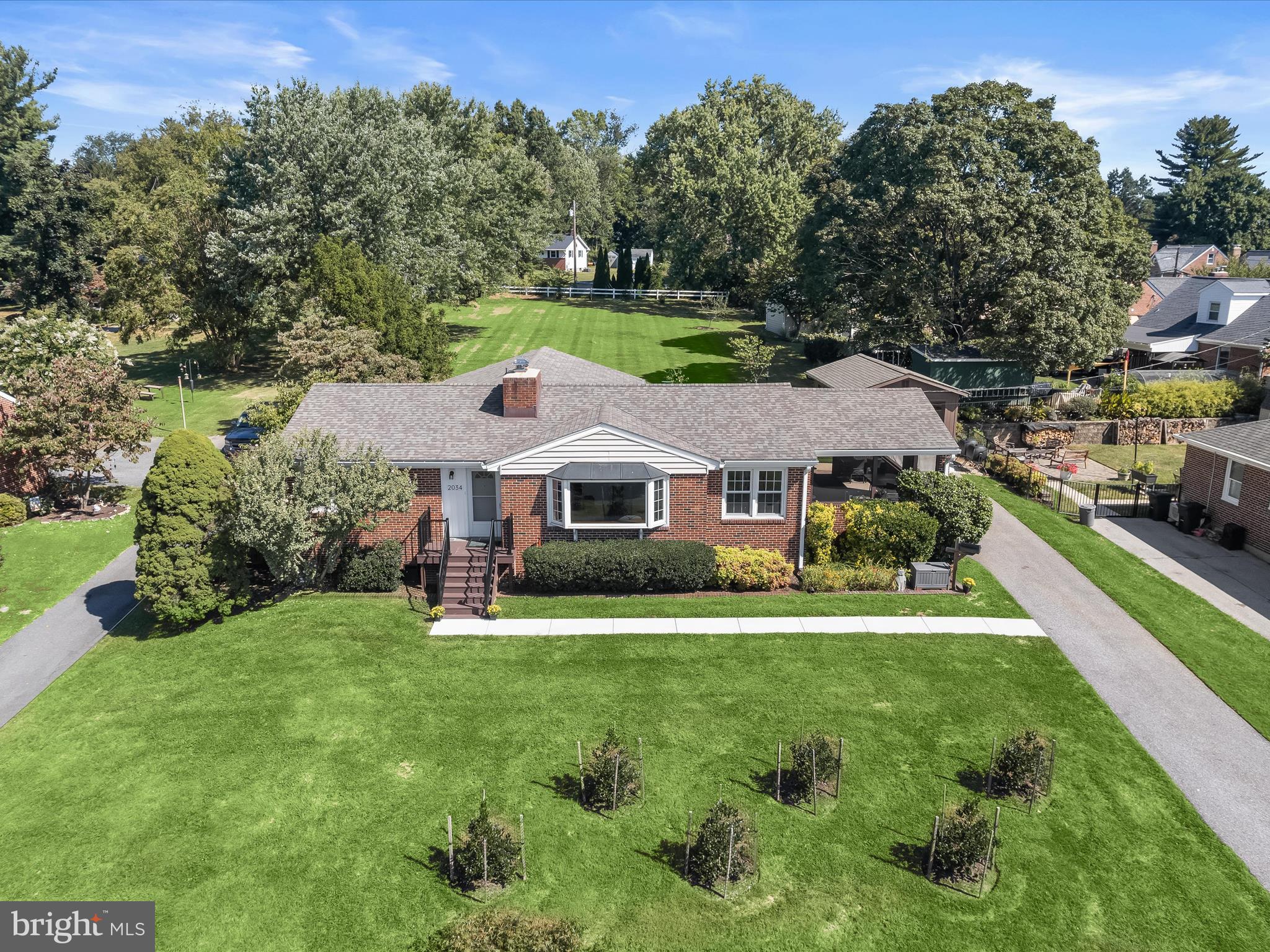 Welcome to this inviting 4-bedroom, 3-bath home perfectly situated on nearly three-quarters of an acre of thoughtfully landscaped, level grounds at the end of a quiet street. A slate-tiled foyer leads to the sun-filled living room, where beautifully refinished hardwood floors, a large bay window, and a raised-hearth, brick-surround wood-burning fireplace, recently relined, create a warm and welcoming space. Flowing seamlessly from the living room, the dining area offers scenic views of the tree-lined lawn. Through a graceful arched entryway, the eat-in kitchen features granite countertops, new stove, a double sink, ceramic tile floors, and direct access to a breezy screened porch, ideal for both relaxing afternoons and lively gatherings.
The primary bedroom offers hardwood flooring and French-style sliders opening to a patio surrounded by colorful seasonal blooms. Three additional bedrooms and another full bath complete the main living level.
The lower level provides abundant space for recreation and entertainment, with a second wood-burning fireplace (also recently relined), a full bath, and a spacious laundry-utility room that includes storage and workshop potential.
Notable updates include: Newly Installed Garage with Electric (June 2025), New High Efficiency Carrier Air Conditioner - 19.5 SEER (December 2024), New High Efficiency Bosch 3 zone Boiler - 3 zone, 95% (November 2024), New High Efficiency Marathon Water Heater (November 2024), New Front Loading LG Washing Machine (November 2024), New Basement Exterior Door (March 2025), Expanded Front Porch, Steps, Front Sidewalk & Screened Side Porch (March 2025)
Additional Energy Saving Improvements, including replacement windows, a newer architectural shingle roof, new lighting, new low-flow toilets upstairs, bathrooms, and added insulation/sealing in the attic and basement.
Experience the perfect balance of tranquility and convenience that this home offers with its proximity to shopping, dining, recreation, and major commuter routes.