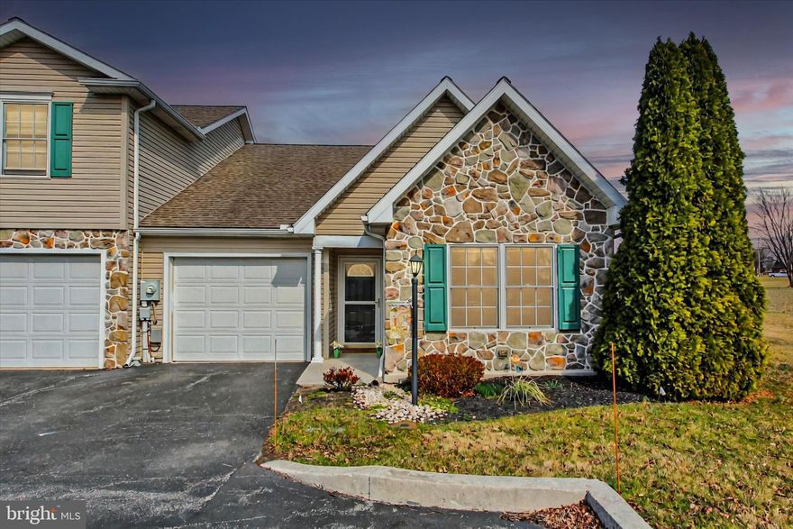 Beautiful, affordable, one-floor, maintenance-free living in  charming , historic New Oxford.   Open floorplan includes great room for  kitchen, dining and living- featuring luxury vinyl plank flooring.  2 separated bedrooms  (one with vaulted ceiling) for privacy.  Main bedroom includes full bath with walk-in shower, walk-in closet, and ceiling fan.  Full hall bath.  Kitchen includes island with stools, pantry cabinet,  and flattop stove. 1 car garage with access to heatpump with natural gas backup unit in attic (pull-down steps).  On-demand water heater also hangs in garage.  Enjoy sitting on rear composite deck (with remote conbtrol awning) and watch the sheep farm across the street!  Just a short walk to the New Oxford square. where you can do a little shopping, then relax at the local coffee shop/ bakery or grab lunch at the sandwich shop. Of course New Oxford is know for it's collection of antique shops!  HOA includes snow removal, lawn maintenance and exterior maintenance/replacement for each unit.