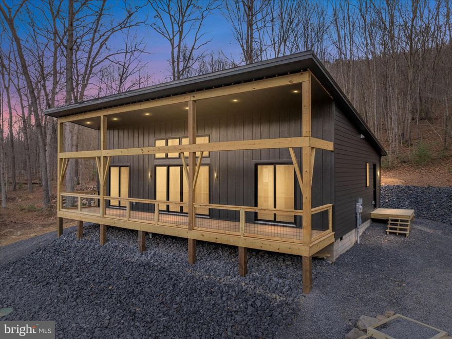 NEW CONSTRUCTION! 

Modern Mountain Retreat – 3 Bed | 2 Bath | 1,380 Sq Ft
Step into 1,380 square feet of thoughtfully designed modern living, where comfort meets nature. This 3-bedroom, 2-bathroom home abuts the serene backdrop of the George Washington National Forest and is just minutes from the Trout Pond Recreation Area, shopping and dining in Lost River Valley, and dining and organic farmers market in Wardensville. Perfect for outdoor enthusiasts seeking hiking, fishing, and boating adventures. The exterior features LP Smart-side siding and a sleek black metal roof, accented by a welcoming covered front porch—ideal for morning coffee or evening sunsets. Inside, the home dazzles with tongue-and-groove wood ceilings in the main living space, Pergo flooring that combines durability with style, and quality finishes and fixtures throughout. The modern kitchen is a chef’s dream, boasting custom cabinetry, quartz countertops, and all-new LG appliances. Relax in front of the electric fireplaces in both the living room and primary bedroom, adding warmth and ambiance year-round. Every detail in this home balances style and functionality, creating a seamless retreat from the everyday, all while keeping you connected to the stunning West Virginia landscape just outside your door.