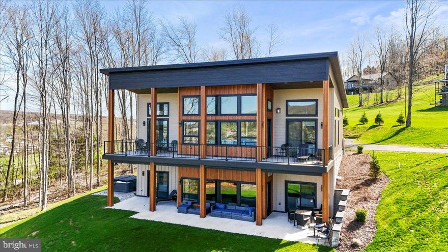 "Sunset Sky Lodge" Views, views, views! This stunning custom home built in 2024 isn’t just a home—it’s an experience and one of Deep Creek Lake's most loved rentals offering an average daily rent of $735 and gross annual projected rental income of $128k to $146k! With breathtaking, unobstructed sunset views over Deep Creek Lake, Wisp Ski Resort, and the mountains, you’ll have front-row seats to Fire on the Mountain 4th of July fireworks and the ski slopes glowing at night in the winter.

Designed for both comfort and style, this home features four spacious primary suites, each with its own en-suite bath and private balcony overlooking the lake. The open-concept living area is filled with natural light from expansive windows, seamlessly blending indoor and outdoor spaces. The kitchen is an entertainer’s dream, with sleek stainless steel appliances, custom cabinetry, and a spacious island perfect for gathering with family and friends. The soaring wood ceilings and beautiful floors throughout are a showstopper!

Step outside to a maintenance-free wraparound deck, a huge patio, and a cozy fire pit where you can enjoy your morning coffee, take in the lake views in the afternoon, and unwind under the stars in the evening. Every detail has been thoughtfully designed to make the most of this incredible setting.

This home is fully furnished inside and out with high end furnishings and decor, and everything conveys, making it truly move-in ready. It also holds a TVRU rental license for up to 12 guests and has a strong rental history. Dock slips may be available, adding to the appeal of this lakefront lifestyle. Whether you're looking for a peaceful retreat or an adventure-filled getaway with easy access to boating, fishing, skiing, and local dining and shopping, this home offers it all. It is ideally situated in the middle of everything the lake offers!

No expense was spared in this home, and that's why it's one of the most loved short-term rentals on Airbnb and VRBO!

Don’t miss your chance to own this incredible Deep Creek retreat—schedule your tour today!