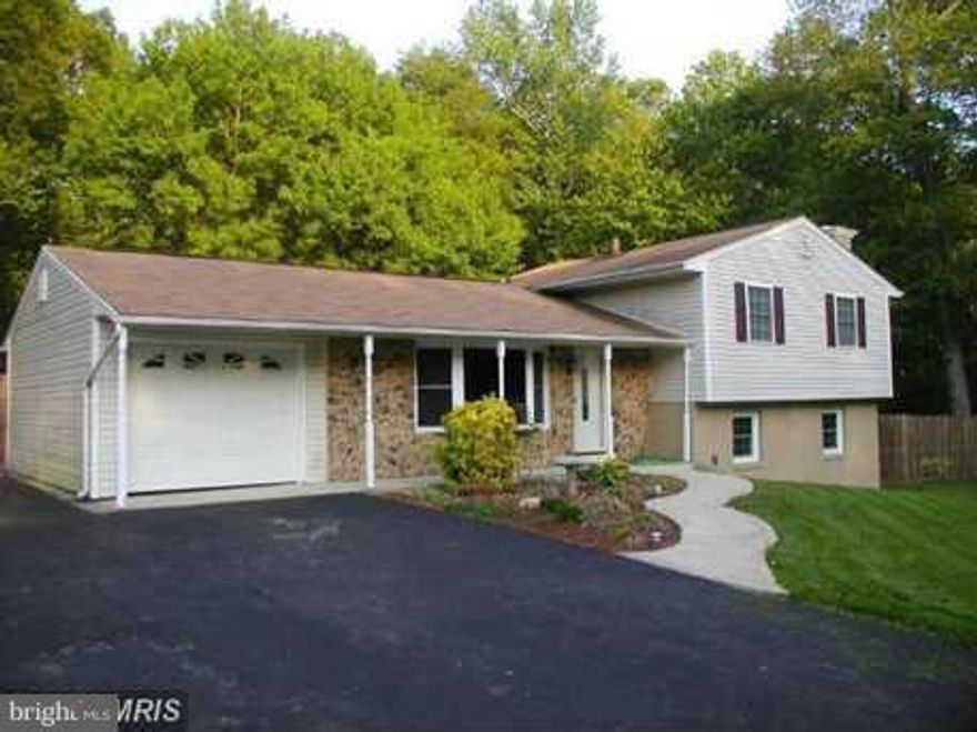 JUST REDUCED !  Check it out. This Home has a lot to offer. Custom Kitchen Cabinets w/ Granite counter tops, CT & Hardwood Floors, renovated Baths, custom trim, a spacious deck, Large fenced in backyard, and a separate Pergola. Home has a heat pump w/ oil back up and a fire place insert.