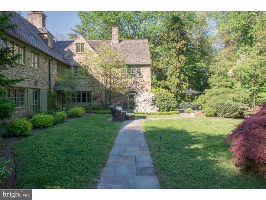 Introducing Froheim, a 1920 Cotswold Revival mansion designed by Robert McGoodwin for Hollis Wolstenholme. Situated away from the crowds with nearby access to the Fairmont Park trail network, this estate is situated on a large 2.3 acre parcel tucked away on a small dead-end street. Perched on a slight rise, it commands distant views over the neighboring woods, providing great privacy. There is an understated elegance to Mr. McGoodwin's design that remains timeless to this day. Enter into the house & you'll immediately notice the round vestibule window, carved entry doors, limestone floors & hood molds. A gracious entry foyer has 1 of the 7 wood burning fireplaces. There is a wonderful indoor/outdoor connectivity through a series of French doors from almost every room. The long axis of the house faces South, providing exceptional light throughout the day. The living room has a set of built-in cabinets, windows on both North & South sides & a detailed fireplace mantel. Behind the living room is the Library (3rd fireplace) and beyond that is the heated Sunroom with stone arched windows. Tucked off the Foyer is the powder room & wet bar that leads into the butler's pantry & kitchen. The spacious dining room (4th fireplace) has access to another sunroom & the family room that was added to the rear of the home (5th fireplace). The laundry/mudroom is tucked behind the kitchen & accesses the rear courtyard & garage. The master suite (6th fireplace) has multiple closets, a huge walk-in dressing room & a large period bathroom (with a separate tub, steam shower & the most unusual in-floor scale!). Three more full baths & 4 bedrooms (one with the 7th fireplace & sleeping porch) complete the 2nd floor. On the 3rd floor are 2 more bedrooms, 1 bath, a sitting room & a huge cedar attic storage room. The most delightful in-law apartment is over the garage (with a kitchen & direct outside access). While the house is spacious, none of the individual rooms are over-scaled, it is a quite comfortable property. With 7 zones for heating & 5 zones for A/C, one can easily control the comfort for large parties or individual nights at home. The cedar roof is less than 10 years old and is in pristine condition (installed by Kurtz Roofing in 2007 & 2011). Tucked at the rear of the property is a fantastic 4-stall horse barn with a tack room, full power & water, a security system along with a fenced paddock with a run-in shed! Come explore Froheim (House of Joy) and make it yours today!