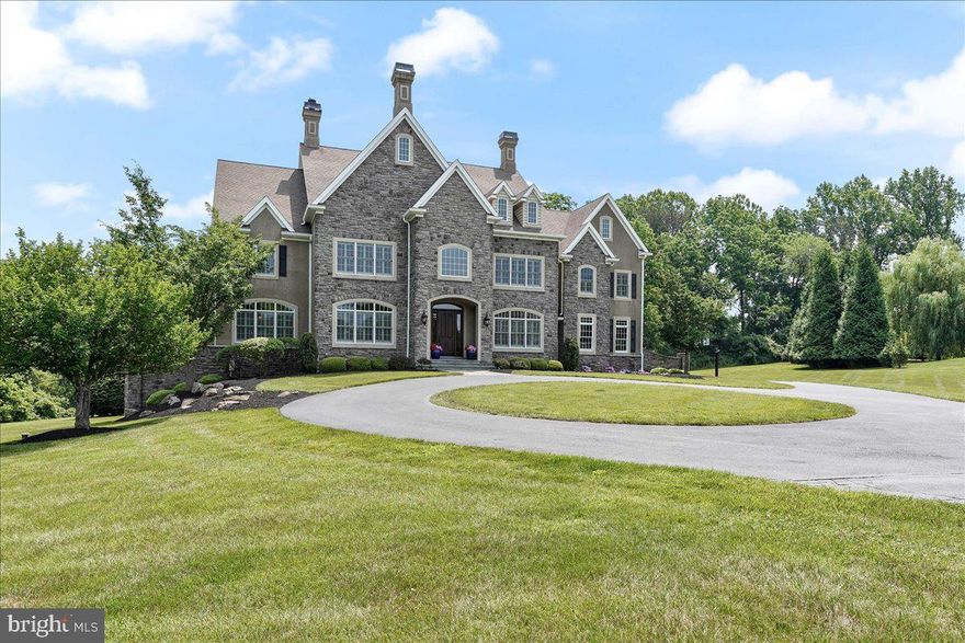 Welcome to 216 Fulling Drive, an extraordinary estate nestled in the sought-after community of Chadds Ford. This five-bedroom, 8-bathroom architectural masterpiece spans an impressive and expansive meticulously designed living space, all residing within a tranquil 5+ acre lot on  Burrows Run Tributary.  Entering the neighborhood, you are greeted by a beautiful horse farm then enter the cul-de-sac property with circular driveway, setting the tone for what's to come. The grand foyer immediately exudes elegance upon entrance. It ushers you to the stately formal dining room and multiple spacious living areas, each showcasing one of the home's four inviting fireplaces and custom hardwood flooring. At the heart of the home lies a gourmet kitchen, a testament to thoughtful design and luxury. Equipped with two sizable islands, top-of-the-line appliances including a six-burner stove with pot filler, two dishwashers, and a wine refrigerator - this kitchen is a culinary enthusiasts dream! The kitchen also features opulent granite countertops, an abundance of soft-close cabinetry for storage and a walk-in pantry offering ample space for all your cooking needs. The chef's kitchen is open and flows effortlessly to the light-filled beautiful family room with a floor to ceiling stone fireplace. The perfect design for gatherings and relaxation. Adjoining the kitchen is an extraordinarily large mudroom providing practical storage solutions and maintaining the cleanliness of your home. Off the mudroom is a half bathroom and the gleaming hardwood back staircase to the upper level. Enhancing the home's convenience and luxury is a modern elevator effortlessly connecting all levels of the home. Upstairs, discover a lavish primary suite offering dual walk-in closets and a private spa-inspired bathroom. Each of the remaining bedrooms is generously proportioned, filled with natural light, and features its own en-suite bathroom and walk-in closet for ultimate comfort and privacy. For added convenience, two sets of washers and dryers are situated in the upstairs spacious laundry room. The professionally finished basement serves as the ultimate entertainment hub with a built-in bar featuring granite countertops and a fully equipped theater room with eight leather movie chairs. Outside, your private retreat awaits! Featuring an expansive deck and lower level stone patio overlooking the beautifully maintained backyard offering beautiful serene lawn space and your own wooded acres with two streams and walking trails. On the back you abut a 20 acre homestead giving added privacy.  The crown jewel of the outdoor space is a sparkling pool with two waterfall features, soothing hot tub and outdoor fireplace for cold nights, relaxation and entertainment.   All TVs and Sonos Sound System  installed in the property are included in the sale providing seamless entertainment throughout. A spacious three-car garage ensures ample storage and parking. Located in Chadds Ford, this home offers the best of community living - access to top-rated schools, a variety of shopping and dining options, and easy access to Longwood Gardens (3 miles), Wilmington Train Station (9 miles), and Philadelphia Airport (22 miles).  With its beauty and grandeur including dual staircases, numerous fireplaces, well-appointed kitchen, expansive mudroom, theater room, bar, whole home generator, plantation shutters throughout, and a host of outdoor amenities, 216 Fulling Drive truly exemplifies a harmonious blend of luxury, comfort, and style. Don't miss this dream home!