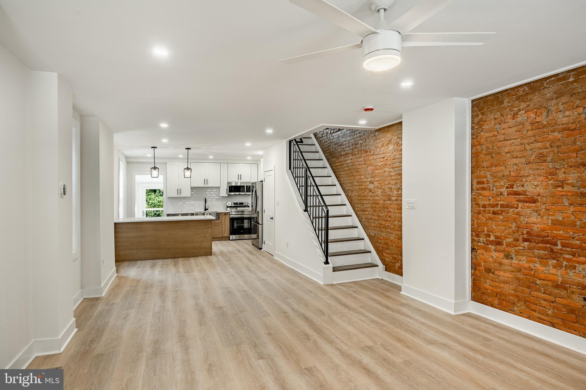 Welcome to this beautifully renovated 4-bedroom, 4-bathroom home in highly desirable West Conshohocken. Blending historic charm with modern updates, this 1,900 sq ft home features exposed brick, contemporary lighting, all-new windows, and a brand-new kitchen. The open-concept main level flows from the spacious living and dining areas to a Trex deck overlooking a large, fenced backyard, perfect for entertaining or relaxing. Upstairs, you'll find two bedrooms and two full baths, including a junior suite with dual closets and a designer en-suite. The sun-filled third-floor primary suite offers space for a home office, generous storage, and separate climate control. The fully finished basement adds even more versatility with a full bath, closet, walk-out access, and extra storage. Additional upgrades include new plumbing, electrical, newer HVAC, and two mini-splits. Just minutes from major highways, this move-in-ready home offers the perfect balance of timeless character and modern convenience.