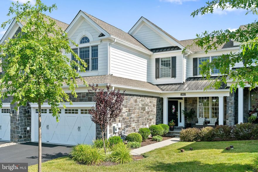 Prepared to be impressed with this stunning and stylish 1st floor primary suite “Vera” model home in the highly sought after Liseter community! Enjoy the many amenities this resort style community offers such as Pool, Tennis, Pickleball, a beautiful Clubhouse with Gym, stunning Party/Event space and so much more. Situated in a quiet section with a lush grassy knoll across the street, 3802 Meadow View Farm Rd boasts 4 Bedrooms, 3.5 Bathrooms and is loaded with upgrades. Five years young and very lightly lived in, this home shows like new construction. The covered front porch is both inviting and a nice place to sit and enjoy the surroundings. Upon entering the home, the dramatic 2 story front Foyer with a turned staircase provides a glimpse into this sophisticated home with its soothing color palette, neutral décor, abundant hardwood flooring and terrific natural light. A Dining Room with a gorgeous tray ceiling, wainscot and crown molding is at the front of the home and is a generous size for your entertaining needs. The heart of the home is the open concept design of the intertwined gourmet Kitchen and Family Room. With crisp white perimeter cabinetry, a large navy center island, Quartz countertops, Jenn Air cooking and a Sub-Zero refrigerator, the kitchen is a chef’s delight. With plenty of space for a breakfast area, the Family Room living space is completely open and adjacent to the kitchen. The gracious family room offers a vaulted ceiling, built-in cabinetry flanking the gas fireplace, terrific windows and access to the expanded and oversized composite deck with pergola. This first floor flows seamlessly for daily living and entertaining. Continue to the tranquil Primary Bedroom Suite providing another vaulted ceiling, recessed lighting and a ceiling fan for year-round comfort. The two separate outfitted walk-in closets are convenient.  An ensuite Bath features a double sink white vanity, oversized tiled shower and a private water closet. A Laundry Room and lovely Powder Room complete this well-designed floor. Ascend the staircase and you will discover an open loft which is ideal for a home office with a built-in desk, cabinetry and shelving as well as a nook for tv watching or reading. Two generously sized Bedrooms share the full hall Bathroom with its double sink vanity and tub with shower head. The walk-out Lower level provides additional living space for exercise or recreation and there is also a private Bedroom Suite with a full Bathroom and very sizable closet that includes a laundry hook up. Plenty of unfinished space is home to the mechanicals and any additional storage needs. The 2-Car Garage is accessed from the 1st floor and provides built-in storage cabinetry. To provide peace of mind, the owners installed a whole house generator. Just minutes to terrific shopping, upscale dining and a variety of entertainment options in Newtown Square, Paoli and nearby Wayne, this location is a commuter’s dream with easy access to Amtrak, major arteries and the Philadelphia Int’l Airport. The wonderful walking trails in the adjacent 50+ acre Newtown Meadow Preserve are also enjoyed by many residents in the Liseter community. Don’t miss this wonderful home ownership opportunity and schedule your appointment today!