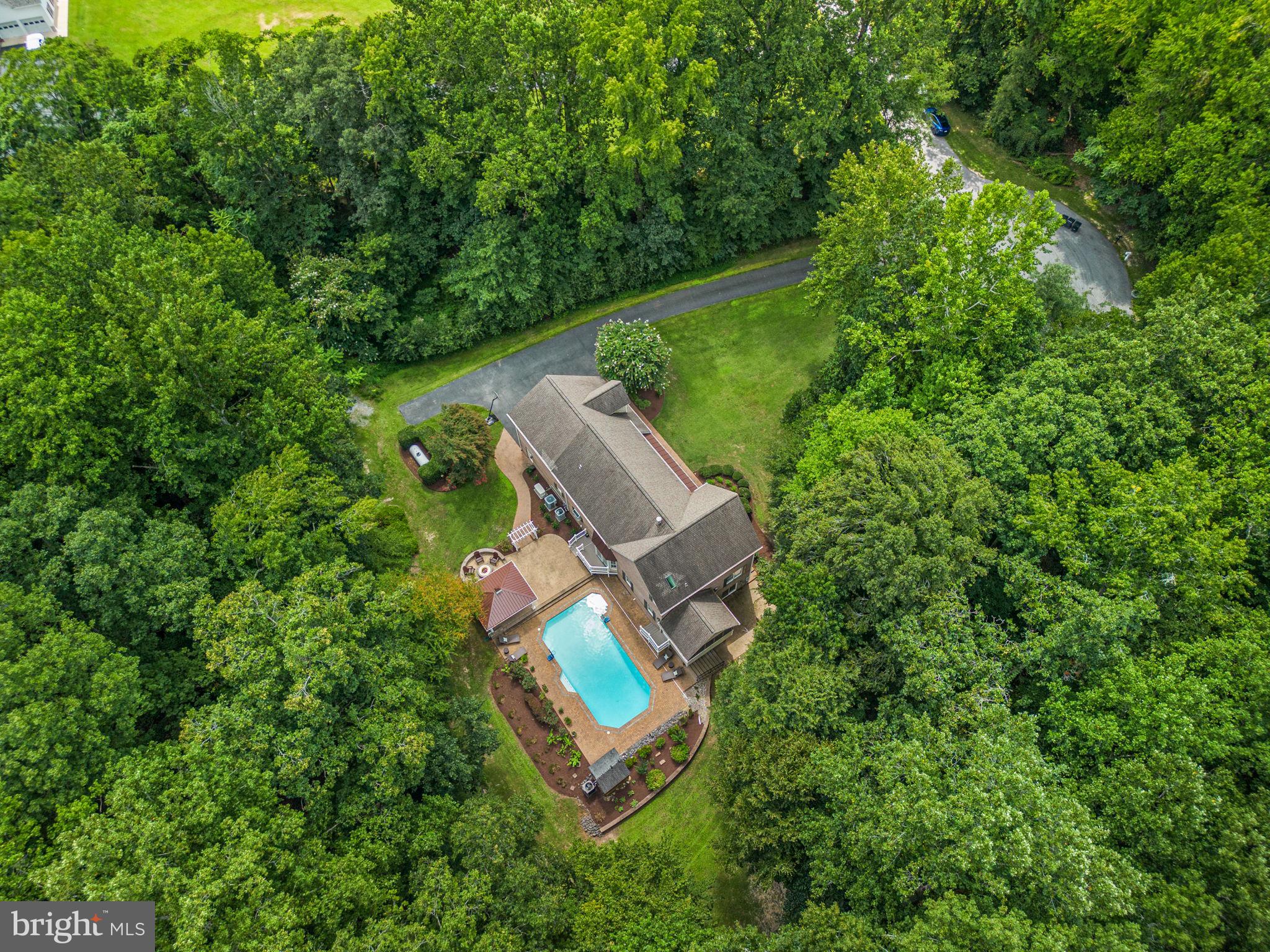 Private 6.37-Acre Brick Estate in the Dunkirk! Welcome to your own private retreat! Stately all-brick home offers the perfect blend of timeless elegance, modern luxury, and serene outdoor living. With almost 4000 sq. ft above grade along with a blank slate 1600 sq. ft basement whether you're hosting friends poolside, exploring the woods, or unwinding on the porch, this exceptional home offers a lifestyle of privacy, comfort, and connection to nature—all just a short drive from the conveniences of town and an easy commute to D.C., Annapolis, or Northern Virginia. Perfect for both everyday living and entertaining, the home features a private salt water HEATED in-ground pool, ideal for summer relaxation and fall swims along with a cozy firepit area for cool evenings under the stars. Meander through your very own wooded walking trails, offering a peaceful escape right in your backyard. The screen porch or covered front porch offer a place to relax, have a beverage and appreciate the serenity of your surroundings. The expansive 3-car fully insulated oversized garage provides ample storage for vehicles, hobbies, or outdoor gear, while the property’s Brick construction ensures long-lasting quality and low maintenance. Larger Bay has 30 amp for RV hookup.
Inside you will find thoughtfully designed living spaces, load of updates and lux appeal including a brand-new $30K Owner's bathroom that exudes spa-like sophistication with high-end finishes and fixtures. Bonus 5th Bedroom extra living space over the garage with large walk in closet. Over a 100K spent on recent upgrades including a whole house generator, water & air purification system, all new carpeting and upstairs zoned HVAC system. Come to Calvert County! The land of peaceful living bordering the Chesapeake Bay and Patuxent River!