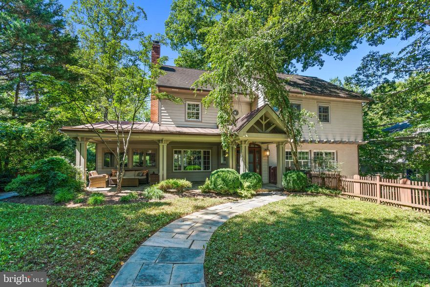 Sited on a private lot in the heart of Glen Echo Heights, 5128 Wissioming Road shines with light-filled contemporary design, dramatic fixtures, and thoughtful details throughout. Delivering 5,000+/- square feet across four finished levels, this 6-bedroom, 4 full and 2 half baths home combines generous proportions with intimate spaces. Finer details include oversized windows, crown and decorative moldings, hardwood floors, and two fireplaces. Multiple outdoor spaces extend the living, providing both serene retreats and entertaining backdrops.
A charming front gate and flagstone walkway lead to a covered front porch that opens into a foyer with high ceilings and an elegant flow. Sunlit living and dining rooms anchor the main floor, complemented by a home office with wood-paneled ceiling and built-ins, a powder room, and a gourmet kitchen with center island and breakfast bar open to the spacious family room. From here, step onto the back deck or down to the expansive patio surrounded by mature landscaping for privacy and quiet gatherings.
The second floor is home to the primary suite, complete with private sitting room, custom walk-in closet, and updated en-suite bath with dual vanities. Two additional generously sized bedrooms with walk-in closets, a hall bath, and laundry complete this level. Need more space? The third level is outfitted with three bedrooms, another full bath with dual sinks and two toilets, along with abundant storage space. The walkout lower level includes garage access via a private entrance, a recreation room, a large storage area, and another full bath.
An attached two-car garage and private driveway add convenience, while the setting places you just a short stroll from the Potomac River and Glen Echo Park. Glen Echo Heights itself is known for its tree-top canopies, trails, and close-knit feel, plus a neighborhood park with playground, basketball court, and multi-use field. With easy access to downtown Bethesda, Friendship Heights, NW D.C., and major commuting routes, this home delivers the best of both: a secluded retreat in a supreme location.  All square footage estimates are believed to be reliable but are not guaranteed.