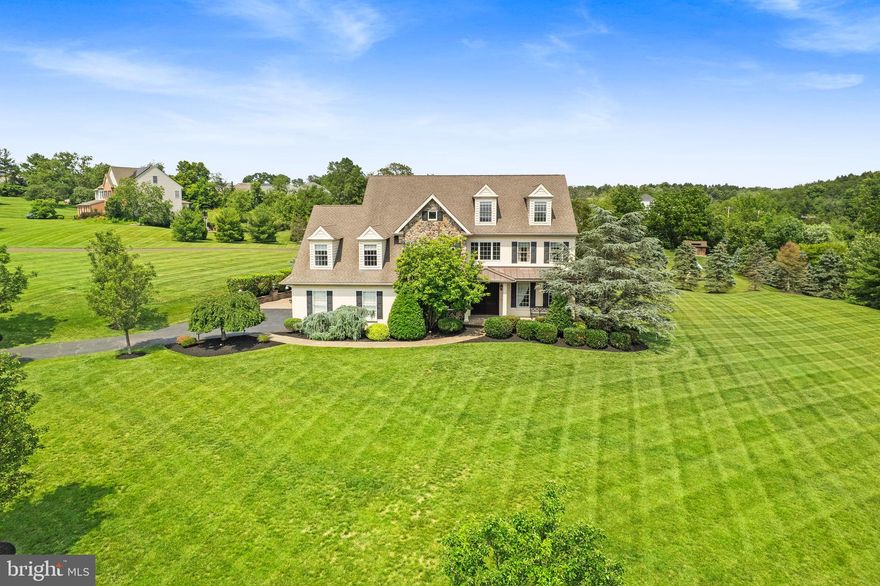 Originally the model home for this sought after community, 4741 MacGregor Drive in Schwenksville is a breathtaking home where timeless craftsmanship meets refined luxury! All set on just under 2 acres of peaceful, tree-lined land. From the moment you arrive, the home makes a bold impression with its striking custom double fiber glass front door, setting the tone for the extraordinary design that unfolds within. Inside, a dramatic floor to ceiling stone fireplace anchors the living space, while two stunning stone columns, framed with a 100 year old reclaimed wood beam salvaged from a historic church, create a sense of division between the kitchen and living room, maintaining an open and connected feel that’s perfect for modern living.

At the heart of the home lies an exquisite chef’s kitchen, featuring rich walnut cabinetry by Diamond Custom Cabinetry, blending beauty and function in every detail. The space is outfitted with a Sub-Zero refrigerator, Wolf six-burner range with built-in grill, double ovens, Wolf microwave, and Miele dishwasher. Italian-imported subway tile lines the backsplash, and warm travertine floors throughout most of the first level add texture and timeless elegance. Upstairs, every bathroom is finished with designer Restoration Hardware vanities, reflecting a consistent dedication to quality and style.

Step outside to an impressive paved patio designed for entertaining, featuring a built-in grill with a direct propane line, ideal for open air dining or summer nights under the stars. A versatile loft offers the option for a fifth bedroom, office, or creative retreat. With four spacious bedrooms on the second floor, four full bathrooms, one half bath, stunning hardwood floors, and abundant natural light throughout, this former model home is as functional as it is beautiful.

4741 MacGregor Drive is more than a home, it’s a rare masterpiece that captures the essence of luxury living, thoughtfully crafted from top to bottom. Schedule your appointment today! Professional photos coming.