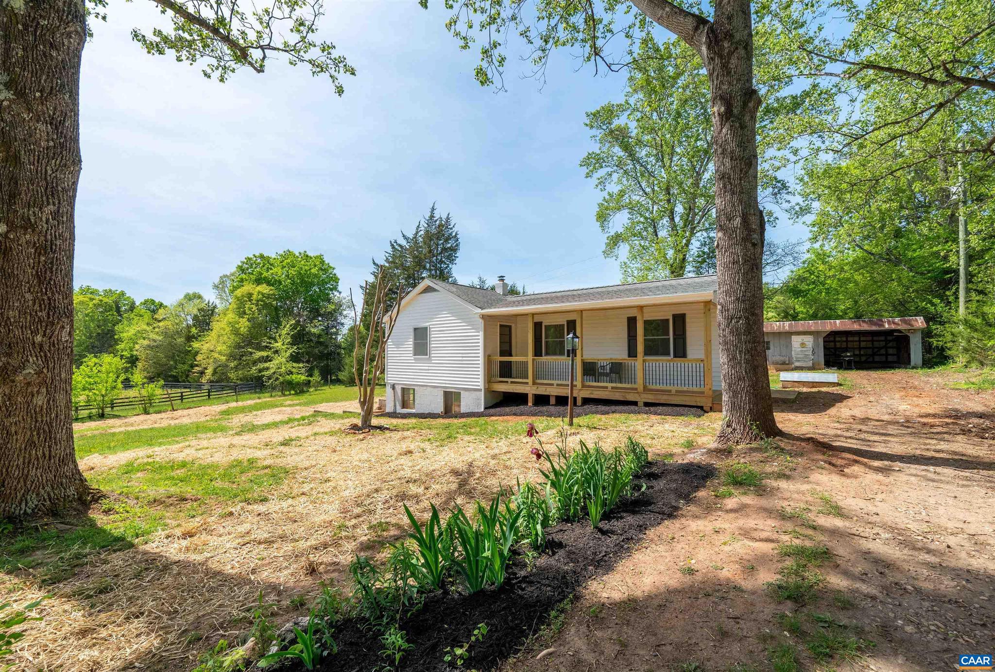 Beautifully remodeled rancher on a spacious 1-acre lot, priced under $300K! This 2-bedroom, 1-bath home has undergone a stunning makeover and is move-in ready. Enjoy breathtaking pastoral views and complete privacy. The large, open lot is perfect for a garden, children's play area, dog run, or hosting family and friends. Sip your morning coffee on the spacious front porch. Inside, you're welcomed by gleaming hardwood floors that flow throughout the main level. A custom mudroom bench offers ample shoe and coat storage. The open-concept kitchen and living area feature butcher block countertops, a tile backsplash, modern fixtures, painted cabinets, stainless steel appliances, and a farmhouse sink. Two spacious bedrooms and a modern full bath complete the main level. The unfinished basement provides excellent storage, a workout area, playroom, or potential for future expansion. Additional features include large two outbuildings for yard tool storage or workshop use and high-speed fiber internet.,Painted Cabinets,Wood Counter