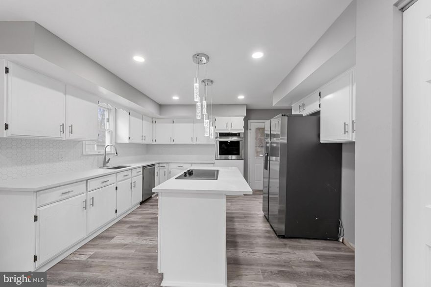 REDUCED!  No expense spared. Come Fall in Love with your new home!  Nestled in a sought-after neighborhood, this large home boasts modern updates including granite countertops, marble floors, modern Zen baths plus an abundant natural light throughout. With over 5,000 square feet of living area, this home includes multiple gathering spaces, ideal for entertaining or relaxing with family. The open-concept design flows seamlessly from the living room to the dining area and well-equipped kitchen.  The thoughtfully designed in-law suite is a true highlight, offering a private entrance, a cozy living area, a fully equipped kitchenette, a bedroom, and an en-suite bathroom. It provides the perfect blend of independence and comfort for family or guests. Step outside to a beautiful fenced-in yard, featuring a spacious deck , perfect for dining and summer barbecues.