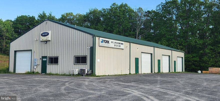 OWNER FINANCING AVAILABLE FOR QUALIFIED BUYERS! 5,000 sf commercial building on 6 acres near Oakland & Deep Creek Lake. Building features include 4 garge bays (all heated), 2 levels of office space with bathroom (800sf), heated concrete floors in most of the property - 3 garage bays. Reznor heating unit in a separate garage bay. Private well & septic system. 2019 added dedicated fiber optic line & installed alarm & camera systems, which all convey. Heavy duty steel roof. 400 amp panel, all electric in conduit. Propane boiler for heated floors. Shown by appointment only, 24 hour notice, M-F.