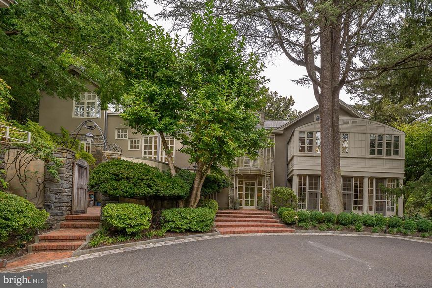 Welcome to 15 Old Gulph Road, an architectural masterpiece in a serene, private location set amidst 1.69 exquisitely landscaped, gated acres featuring over $350,000 in recent enhancements by the current owners. This extraordinary residence is a rare fusion of classic architecture and timeless design with a flexible layout to accommodate any lifestyle. Redesigned in 2012 by celebrated architect Carlas Valhonrat, protégé and colleague of Louis I. Kahn, the home represents a perfect harmony between nature and structure, serenity and sophistication. The unsurpassed beauty of the landscaped gardens generates a peaceful energy that carries forward as you enter the home. The home's design emphasizes light and openness, with floor-to-ceiling windows, wide balconies, secret walled patios, and five fireplaces on the entry floor anchoring the expansive, open-concept living spaces carefully designed to offer stunning views from every window and filling the home with abundant natural light. The main house offers 5–6 bedrooms and 6 full baths, including a luxurious Primary Suite with dual baths, featuring both steam and traditional showers, extensive custom designed closet space, and a third-level dressing room/cedar closet featuring a motorized dry-cleaning-style hanging system. Each secondary bedroom enjoys its own en suite renovated bath, showcasing classic materials used in imaginative ways. A third level on one side of the home offers two bedrooms and full bath while a separate third floor space above the Primary Suite offers an additional Bedroom and full Bath, ideal as a Private Study or Professional Home Gym. The main floor features rich hardwood flooring throughout and a fabulous Kitchen, Breakfast Room & Family Room area that serves as the heart of the home offering. The Outdoor Living Area is equally impressive and truly a gardener’s dream featuring lush new landscaping, mature specimen plantings, new exterior lighting, and a new awning on the lower terrace. A circular inlaid courtyard leads to a two-car garage topped by a charming in-law/au-pair suite with Kitchenette, full Bath, walk-in Closet, Laundry and generous storage. A separate 3–4 car garage with private gated access from Old Gulph Road provides additional space for collectors or enthusiasts and provides the perfect blank canvas to create additional future living space, perhaps a Guest Cottage. Located in one of the Main Line’s most coveted settings, this exceptional home is convenient to the area’s finest private and public schools, country clubs, universities, shopping, dining, trains and major transportation routes to Philadelphia and New York. Schedule an appointment for your private tour today.