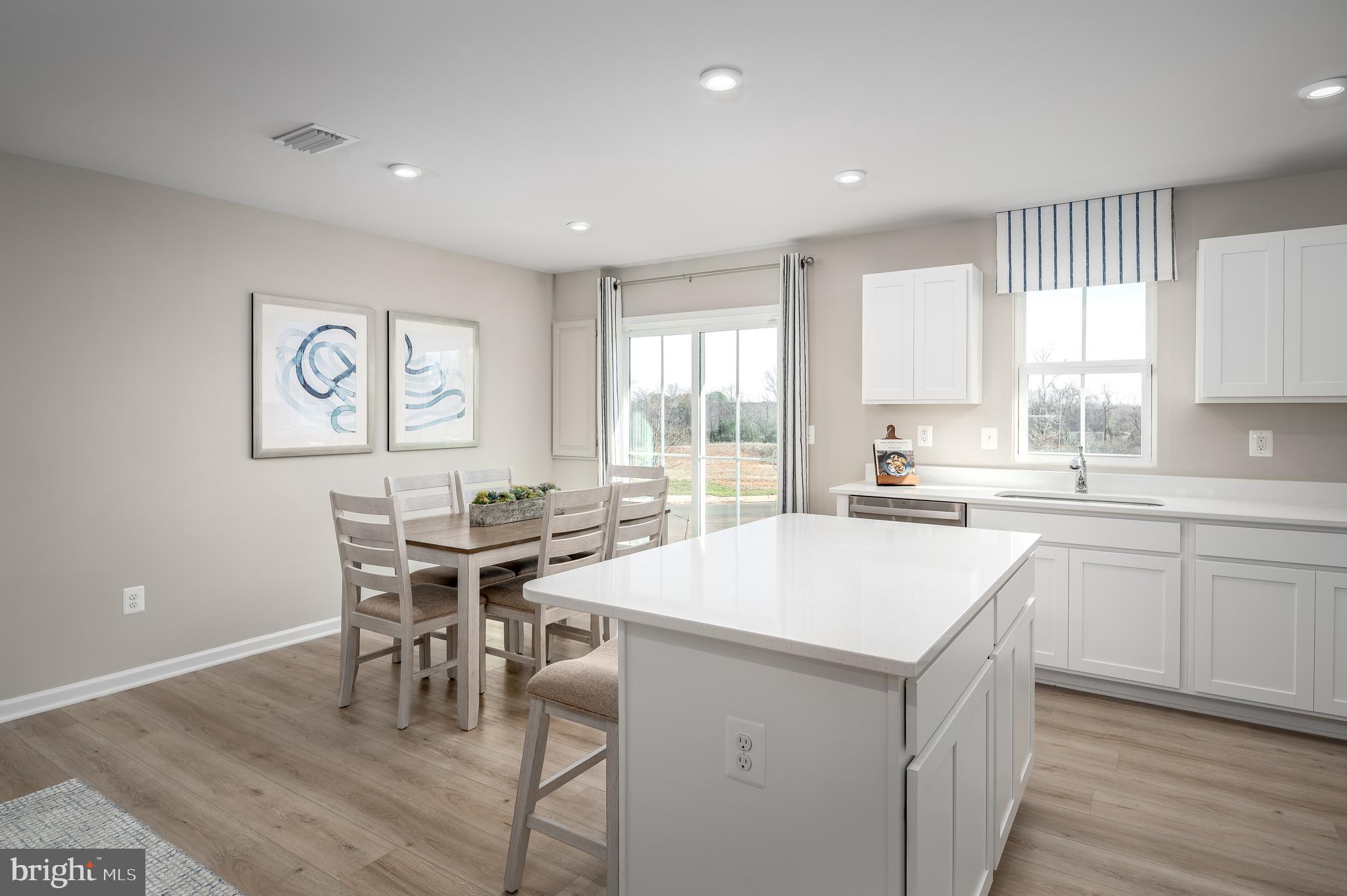 Are you looking for a brand new home but want to move in sooner than later? Then check out the QUICK MOVE IN POPLAR at the Cardinal Pointe Townhomes- move in March/April!! With a wide range of financing options and closing cost assistance, Cardinal Pointe, may just be what you've been searching for! This stunning, brand new 3 bedroom, 2.5. bathroom, 1-car garage townhome features luxury vinyl plank flooring through the whole main level, beautiful white cabinetry, brand new stainless steel kitchen appliances, your washer and dryer in your laundry room, a spacious backyard and more! The Poplar is a perfect blend of modern design and comfort. Enjoy a luxurious primary suite w/ an oversized walk-in closet and private bath, 1-car garage w/ a garage door opener, open concept living area that is perfect for entertaining, large windows and natural light, fully equipped kitchen and an outdoor space that includes the largest townhome yards in the Hedgesville and surrounding areas! This home is located in a vibrant, up-and-coming neighborhood in the most sought after location. Only 15 minutes to Hagerstown, 30 minutes to both Frederick, MD and Winchester, VA and easy access to I-81 and public transportation. Don't miss your chance to own a piece of this beautiful community! Contact us today for a tour. Photos are representative. The model home is located at: 95 Otero Lane, Hedgesville, WV 25427