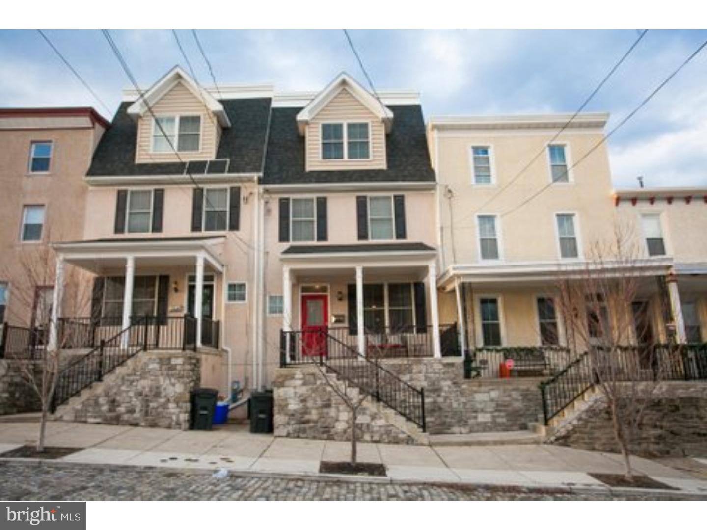 Almost new with a 5 year tax abatement,  this  4 bdrm 2.5 bath Townhome  was featured in The Philadelphia Inquirer and praised for it's architectural design elements and material composition.  The property was noted as one of the few new builds that truly duplicate and complement the original homes  built in the area.  Nestled on a quiet cobble stone street,  you will enter this home through a beautiful covered front porch.  The front door leads to a light filled dining room with a walk-thru to a large chef's kitchen,  featuring  LG SS appliances, granite counter tops and space for a wine refrigerator.  A large center Island  seats 4 and is also equipped with a second sink.  The kitchen opens to the family room featuring gas fireplace, custom bookshelves, beautiful mantle   and a bank of glass windows and door lead out to the composite deck and newly landscaped fenced yard.  Steps from the garden will take you to your private drive with parking spaces  and garage.  Additionally, a half bath and coat closet are located off of the front entrance way.  Up the first flight of stairs you will find a spacious master suite with walk-in closets and  custom shelving.  A glass door in the master opens to a private balcony overlooking the rear gardens. The en suite bath has double granite vanities, large soaking tub, glass enclosed shower and private commode room.  The second floor also features a second bedroom, perfect for office or nursery and a large laundry room.  The 3rd floor has two additional bedrooms with large walk-in closets and hall bath with double vanities and shower/tub combo.  The lower level unfinished basement  is wired for finishing and offers an additional 600 sq. ft. Not only is this home on one of the most beautiful historic vantage points in Manayunk, it is conveniently located within walking distance to Gorgas Park, the Tow path, canal and the shops and restaurants on Main Street.  Great area for young families as day care is a block away and the train at the end of the street.  Whether you are new to the area, downsizing, or looking for a unique urban experience, you will not want to miss touring this home.