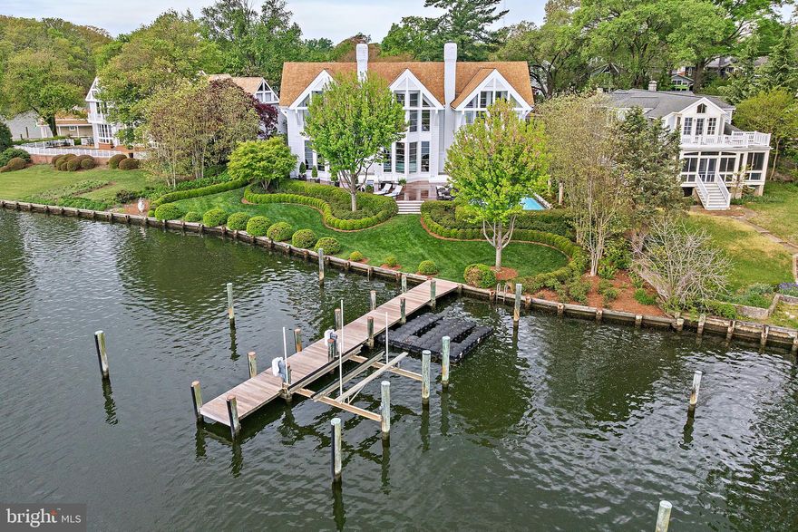 Absolutely one of the finest waterfront offerings in the City of Annapolis. Ideally situated on Spa Creek, this exceptional property boasts sweeping water views and showcases the Annapolis skyline, creating a waterfront lifestyle with a myriad of opportunities for boating, kayaking, and entertaining. Enjoy direct water access with the ability to travel by boat to City Dock, local restaurants, and ice cream destinations—an unmatched Annapolis waterfront lifestyle. A prime vantage point for the Blue Angels, fireworks, and the annual boat parade further confirms the setting.
Set within an exclusive enclave of three prominent homes, the residence features a waterside heated saltwater pool, deep-water pier, and a spacious Ipe deck designed for outdoor living. The grounds are beautifully landscaped with lush boxwoods and specimen plantings, creating a private and serene setting.
Architecturally distinctive and extensively updated, the home showcases high-end renovations by Pyramid Builders. A dramatic marble foyer, floor-to-ceiling windows, and solid wood doors enhance the home’s refined design. The gourmet kitchen is top-of-the-line, featuring Sub-Zero refrigeration, a white 6-burner Viking cooktop, high-gloss Premier cabinetry, Neolith porcelain countertops known for their heat and stain resistance, designer lighting, and a striking floating staircase. A custom bar with a marble countertop is perfectly positioned for entertaining.
Offering 4–5 bedrooms, 5 full and 1 half baths, including a desirable first-floor bedroom, the home also features stained black oak flooring throughout. A two-car garage with ample driveway parking provides convenience for residents and guests alike.
