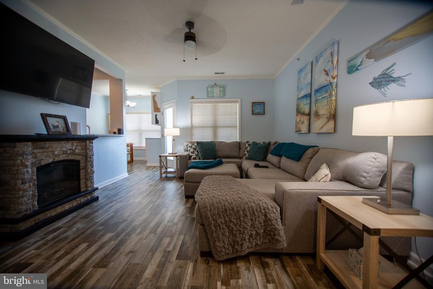 This contemporary 2-bedroom, 2-bathroom unit offers a blend of comfort and modern living in a well-maintained community. Spanning 1,009 sq. ft., the open floor plan features luxury vinyl plank flooring and recessed lighting, creating a bright and inviting atmosphere. The galley kitchen is equipped with upgraded quartz countertops and appliances, including a built-in microwave, range, dishwasher, and refrigerator, with icemaker and the owners added a bar in the dining area that includes a wine cooler making a convenient entertaining area.  New HVAC System in 2022.  This unit is sold fully furnished including 2 50" TV's, Sleep Sofa in the Living Room.  Enjoy the convenience of in-unit laundry with both washer and dryer included. The primary suite boasts a walk-in closet and a private bath with a tub shower, while the second bedroom is perfect for guests or a home office. Additional features include ceiling fans, window treatments, and a sprinkler system for added comfort and safety. Step outside to your screened balcony with storage closet is ideal for relaxing or entertaining and storage for your beach toys or bike. The community amenities enhance your lifestyle with access to a clubhouse, outdoor pool, and tennis courts, all maintained by the association, which also covers lawn care and snow removal. Located in a vibrant neighborhood, residents benefit from nearby shopping, restaurants, grocery store, parks, excellent schools, and convenient to historic downtown Lewes, the Henlopen State Park and both Bay and Ocean beaches. With easy access to local shops and dining, this property is perfect for those seeking a balanced lifestyle in a welcoming community. Don't miss the opportunity to make this lovely unit your new home!  Great rental investment opportunity too.