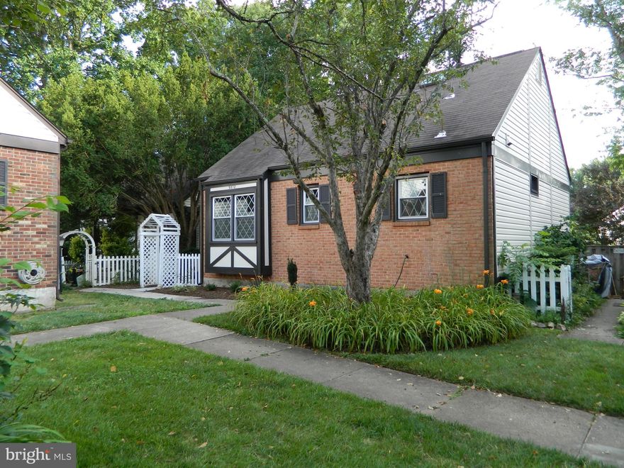 A somewhat unknown gem of a neighborhood!  English Tudor cottages! This three -level home with its newly installed HVAC system is larger than can be imagined.  The interior of the home has been renovated and updated. Starting outside, the new concrete walkway guides you into the side entrance where you are met by new gleaming hardwood floors in the main level living room, dining room and the stairs going up to the upper level and down to the basement .  The living room fireplace has been thoroughly inspected and draws well. The entire interior has been freshly painted with neutral colors trimmed out with a contrasting semi-gloss white.  All of the windows have been replaced with newer double pane windows.  There is a new ceiling fan in the dining room. The kitchen has been updated with granite counters and newer cabinets and appliances, and tile floor. The main level full bath has been updated with a newer granite sink and vanity, newer faucet, tile floor and light fixture. The main level bedroom has new carpet.  The upstairs bedrooms have new carpet.  The full bath with a stand up shower has been updated with a new quartz vanity and sink, light fixture and tile floor.  The basement is divided in half. The well-lit finished side includes new LVT,  and a sliding glass door that provides natural light and looks out onto a large stone back yard patio. The sliding glass door will be replaced with a new door.   On the opposite side there is a storage room with a work bench and an adjacent laundry room with a full size washer and dryer and a utility sink with a new faucet.  There is also a sliding glass door that provides natural light and access to the stone patio. This sliding glass door will be replaced, as well.  There is a rough-in for a sink and toilet for a 3rd bath.  All outlets and GFIs have been replaced throughout the home.  There are new floor registers and all of the door knobs have been replaced.  The roof was replaced in 2016, the siding was replaced in 2012, the HWH was replaced in 2022, and the HVAC system inside and out was just replaced in 7/2023. The back yard is fenced in and professionally landscaped and the large stone patio has been power washed. There are two parking spaces in front that provide easy access to the home. The front of the home has been professionally landscaped. The VRE and the bus stop are walking distance and there is access to major routes including Rolling Rd, Braddock Rd and RT 495, and the Kings Park Shopping Center.