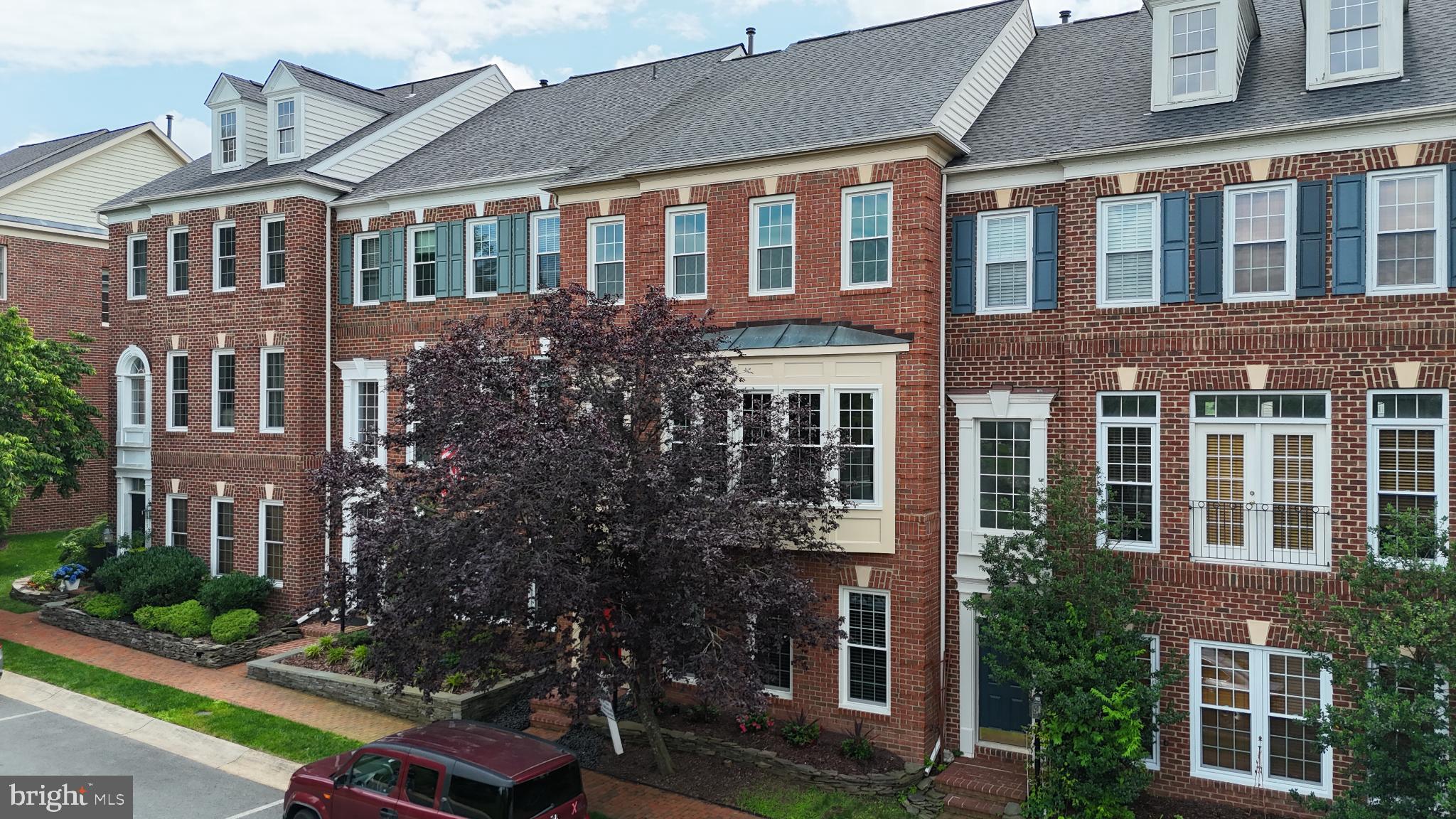 Tucked into one of River Creek’s peaceful streets, this four-level brick front townhome blends timeless design with smart updates and light-filled living spaces that feel instantly welcoming. With approximately 2,779 finished square feet, every inch has been cared for, improved, and designed to enhance everyday comfort.
Step inside and you’ll feel the openness on the main level— sunlight pouring through brand-new 2024 windows  bounces off newly refinished hardwood floors and the whole house painted with a fresh neutral palette. The main level’s open concept gives you an elegant flow from living and dining areas into a beautifully refreshed kitchen featuring a two-year-young sink and microwave, upgraded disposal (2025), and stainless steel appliances including a refrigerator that’s just four years new. The heart of the home opens to a Trex deck (installed 2019) — a low-maintenance outdoor retreat where you can sip coffee, host dinner under the stars, or unwind with leafy community views.
Upstairs, the primary suite feels like a getaway — generous in size with natural light,  a walk-in closet, and spacious bath. The carpet here was replaced just 15 months ago for that soft, new-home feel. Two additional bedrooms and a well-appointed hall bath complete this level, with an upper-level HVAC (NEW 2025!) keeping everything efficient and comfortable.
The fourth level is where the magic continues — a wide-open loft flooded with natural light and offering incredible flexibility. It’s the kind of space that easily transforms with your life: a serene home office, a creative studio, a reading lounge, or a second living area perfect for movie marathons, teen hang out or weekend guests. Framed by the home’s classic dormer windows, it feels both cozy and expansive — a private retreat that invites you to slow down and stretch out.
Downstairs, a spacious open space offers even more versatility — think home gym, play space, or home office — with 2 car garage in the back. The lower-level HVAC  keeps the space cozy year-round, and the newer water heater (2022) ensures hot showers never run out. A newer roof (2019) adds peace of mind, while the Choice Home Warranty, paid through 2028, transfers to the lucky next owner for extra reassurance.
Beyond your front door, River Creek delivers a lifestyle few communities can match. The private, gated neighborhood sits where Goose Creek meets the Potomac — a setting of rolling greens, mature trees, and water views that make every day feel like a getaway. Residents enjoy access to the River Creek Clubhouse, golf course, tennis courts, pool, and walking trails, along with lively neighborhood gatherings and a true sense of place. Just outside the gates, you’ll find favorite Leesburg destinations for shopping, dining, and weekend exploring.
Whether you’re drawn by the natural light, the thoughtful updates, or the rare opportunity to live inside one of Loudoun County’s most picturesque enclaves, this home stands ready to welcome you. Come see why life feels a little more effortless — and a lot more inspiring — on Apache Wells Terrace.