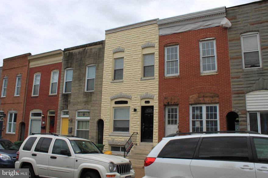 Lovely updated home.  Separate LR & DR with decorative crown molding, exquisite picture framing of exposed brick with track lighting, & beautiful wood floors. Kitchen has ample cabinet space, stainless steel appliances, and granite counter tops. Separate laundry room. Brand new furnace. Finished family room downstairs, with storage room. Lots of closet space. Large rooftop deck with amazing view.