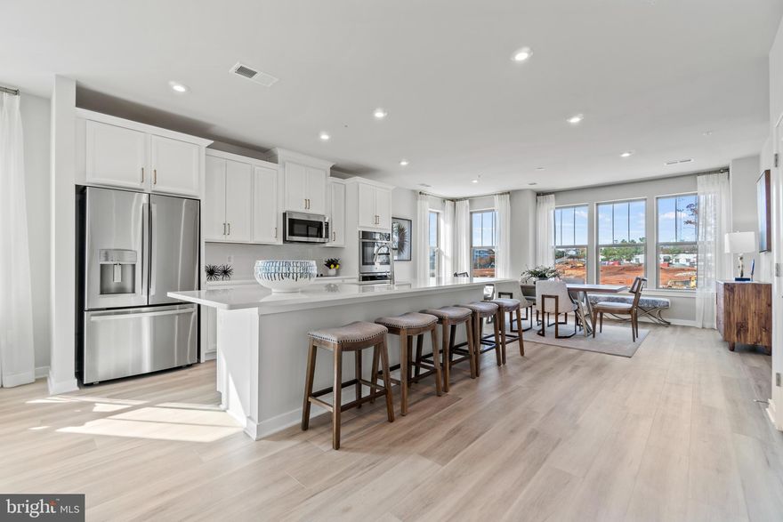 Brand New Stanley Martin 2 Level Garage Condo Village at Manassas Park is conveniently located amongst upcoming shopping, dining, entertainment, and outdoor recreation fun. Commuting convenience and low-maintenance living is what we're all about! 
Introducing the Julianne, our sophisticated upper-level condo. Prepare to be captivated by its elevated layout and contemporary ambiance. Bathed in natural light that streams in from both ends of the main level, the space effortlessly flows from the family room to the kitchen, extending to the inviting eating area. And let's not forget the covered balcony, where cherished memories await in every season, just off the family room. Anchoring the kitchen is a magnificent 12-foot island, perfect for gathering with guests or preparing your signature dishes. Additionally, on this floor, you'll discover the study, providing an ideal workspace for remote professionals. Relax in the elegant primary suite after a long day, boasting a spacious walk-in closet and a bathroom reminiscent of a tranquil spa. Just down the hallway, discover two more bedrooms ideal for guests or as a bonus office area. Photos shown are from a similar home. Contact us to schedule a tour or visit our model homes today!
Just a 2-minute walk to the Virginia Railway Express Station that will take you into Washington D.C. Spend less time with commuting and maintenance and more time making memories with loved ones at home. Manassas Park City Hall at Park Central offers brand new 2-level public library with a brand-new Sprinkler Park! Come tour the model homes today!