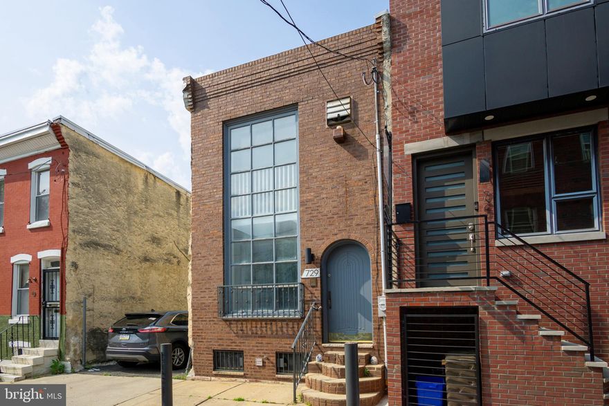 Welcome to this super unique trinity house on a great South Philly block. The first floor is beaming with natural light through the oversized front window. The open concept layout features newer ceiling fans, fireplace and recessed lighting. The eat-in kitchen features a center island, stainless steel appliances and more recessed lighting with sliding glass doors to the rear sitting area. Up the first spiral staircase is a large front bedroom with endless natural light from the two story front window. The second bedroom in the rear is accompanied with a large hall bathroom. Up another spiral staircase is a third bedroom with sliding glass doors to a roof deck. This home is one of a kind, make an appointment today to check it out!