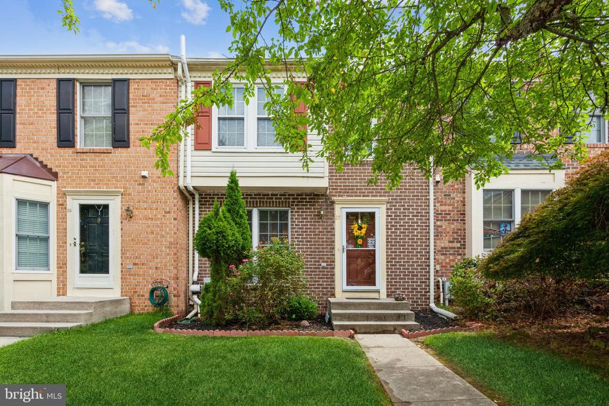 Beautiful brick front townhome! This is a  Two master bedroom home, each with own full bath! Premium lot view which backs to woods.  Powder rooms on main and lower level for your convenience. Hard wood floors in open family room and separate dining area. Slider opens to a gorgeous deck off of the bright and sunny kitchen. Enormous finished basement with walk out to private back yard.  Great for entertaining and  just enjoying the view!