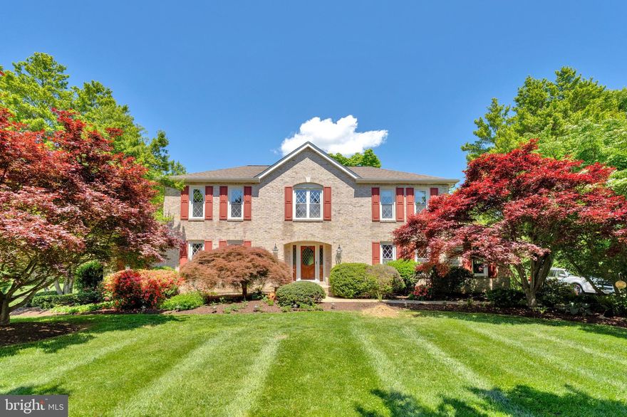 Set against the scenic foothills of the Bull Run Mountains, Evergreen Farm / Evergreen Country Club offers a peaceful enclave of just over 100 homes known for its sweeping mountain vistas, generous acreage, and access to the Evergreen Inn and its 18-hole championship golf course.
This beautifully crafted brick-front Colonial is thoughtfully designed and impeccably maintained, set on a picturesque 5.16-acre lot backing to a 227-acre working farm. The property delivers exceptional privacy and a true retreat-like atmosphere. The expansive rear deck—complete with an outdoor kitchen—overlooks an impressive 8-foot heated in-ground pool, two fully stocked ponds with fountains, and meticulously curated grounds featuring vegetable and flower gardens, mature flowering trees, ornamental grasses, and elegant hardscaping. A registered Purple Martin colony with 24 birdhouses adds a unique and charming touch to the landscape.
Inside, the home offers over 4,100 finished square feet across three levels, including four bedrooms and three and a half baths. Hardwood floors run throughout the main living spaces. The sun-filled living room features walls of windows and a gas fireplace with a marble surround and custom wood mantel. The formal dining room showcases a bay window and refined crown molding.
The family room impresses with vaulted ceilings, skylights, and a dramatic floor-to-ceiling brick fireplace. The kitchen is appointed with natural cherry cabinetry, granite countertops, a center island with cooktop, stainless steel appliances, recessed lighting, and ceramic tile flooring, plus a bright breakfast nook with direct access to the deck.
Upstairs, the spacious primary suite includes a dressing area, walk-in closet, and a luxurious bath with skylights, a Jacuzzi tub, and double vanity. The finished lower level is ideal for entertaining, featuring a custom Irish pub-style bar with seating, a full bath with walk-in shower, a cozy den with a ventless gas fireplace, a cedar closet, and abundant storage.
Additional highlights include an oversized side-load two-car heated garage with a 30-amp RV hookup, two storage sheds, dual-zone heating and cooling (heat pump and propane), and a private artesian well independent of the community system.
Residents also have the option to join Evergreen Country Club, with memberships available for golf, pool, tennis, and dining.