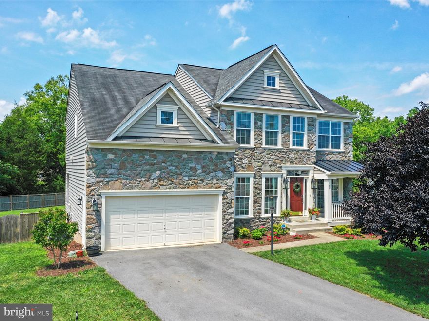 Step into luxury with this stunning stone-front Colonial home! Bathed in beautiful natural sunlight throughout the afternoon and evening, this home stays bright even in winter. The main level boasts a spacious open floor plan with 9' ceilings, hardwood and ceramic tile flooring, and elegant crown molding. Cook in style in the huge remodeled gourmet kitchen with quartz countertops, gas cooking, double wall oven, and large island. Relax in the cozy living room with a stone profile gas fireplace. The primary suite features a sitting room with wet bar, and the primary bath has an oversized sunken tub, a separate tiled shower with a built-in seat, and double vanities. Upstairs, there are three more bedrooms and a full bath to share. The lower level is perfect for entertaining, with a recreation room, custom bar, game room, media room, fifth bedroom, full bath, and additional unfinished space. Outside, enjoy the park like setting with privacy-fenced backyard, large patio, and deck.   All this situated on a peaceful cul-de-sac. This home is truly a gem!