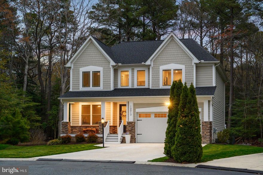 In the sought-after community of Glen Riddle, this is one for your short list be it for your year-round home, beach house or an investment (it’s a great golfers’ homebase). Here is a property with a perfect combination of luxury, comfort & convenience that’s ideally nestled on a lot that affords tranquil living among natural surroundings. Making this well-built 4 BD, 3.5 BA single-family home shine bright are the popular features & premiums that are spread throughout the 3,170 sq. ft. The curb appeal already reveals the beauty of this home! Centered around the charming front porch & the 2-car garage entrance featuring distinctive white posts and incredible rough-cut stone. Upon entry you see the fine craftsmanship with the attractive luxury vinyl plank (LVP) flooring. A few steps later you are in the grand open concept area that creates a warm & inviting space for both daily living and entertaining. Two prominent features here are the striking fireplace with its raised hearth & shiplap wall and the other is the large center island in the gourmet kitchen. The rest of the kitchen is a cook’s delight with its impressive appliances like the Bosch gas grill-top stove & oven. Adding to the kitchen’s stunning look are the striking vent hood and the exquisite tile backsplash with gorgeous Quartz counters! More desirables are the walk-in pantry, select glass cabinets, beverage cooler & eat-in area. The checklist items continue with a 2nd dining area, elegant living room tray ceiling and the abundant natural light. Through the kitchen is the powder room & a mudroom leading to the garage and at the front of the home is an office. A real treat is to step into the sunroom. Why is it so appealing: (1) you can enjoy it year-round thanks to a ductless heat & a/c system, (2) there’s a mighty gas fireplace with a prominent stone hearth & mantel, and (3) you are steps closer to the natural beauty outside easily seen through the wall of windows! Now, go outside to the expansive bi-level outdoor oasis where you can enjoy peaceful days & nights while watching an array of birds among other wildlife! It starts with a spacious deck then steps down onto a huge paver patio with an oversized half stone wall with an outdoor grill & large counter space and that’s just on one side; the other side has a gas firepit. Enjoy it all in this awesome space: unwind with your favorite beverage, dine al fresco, meditate, have your morning coffee, entertain, read a book, you name it. Back inside, the 2nd floor is where the 4 bedrooms are along with the utility room which has upgraded built-in shelves, cabinets and a sink. Two of the BDs are ensuite and all have closet organizers. The owners’ suite has 2 walk-in closets and everything in the bathroom is first-class: slate flooring, luxurious soaking tub, dual vanity with plenty of cabinets and a large walk-in shower. You will be delighted by its beauty when touring this home in person and as you discover other premiums & features not listed here. Glen Riddle is among the top communities in the area and only 4 miles to Ocean City & half that to West OC, 10 miles to Assateague, & 5 to historic downtown Berlin. This stellar community is close to so many shops, stores, family fun, places to dine & drink, the harbor and more! Amenities include: an outdoor community pool w/ hot tub, 2 premier championship golf courses, tennis courts, fitness center, kids’ playgrounds, marina with a boat ramp and on-site security. The onsite restaurant, Ruth’s Chris Steak House, does a wonderful job of telling in written form along with pictures & paintings about the equestrian history here which is not to be missed.  In Person or By Video, set your appointment to see this one soon! Remember, Life is Not a Dress Rehearsal, Own at The Beach!